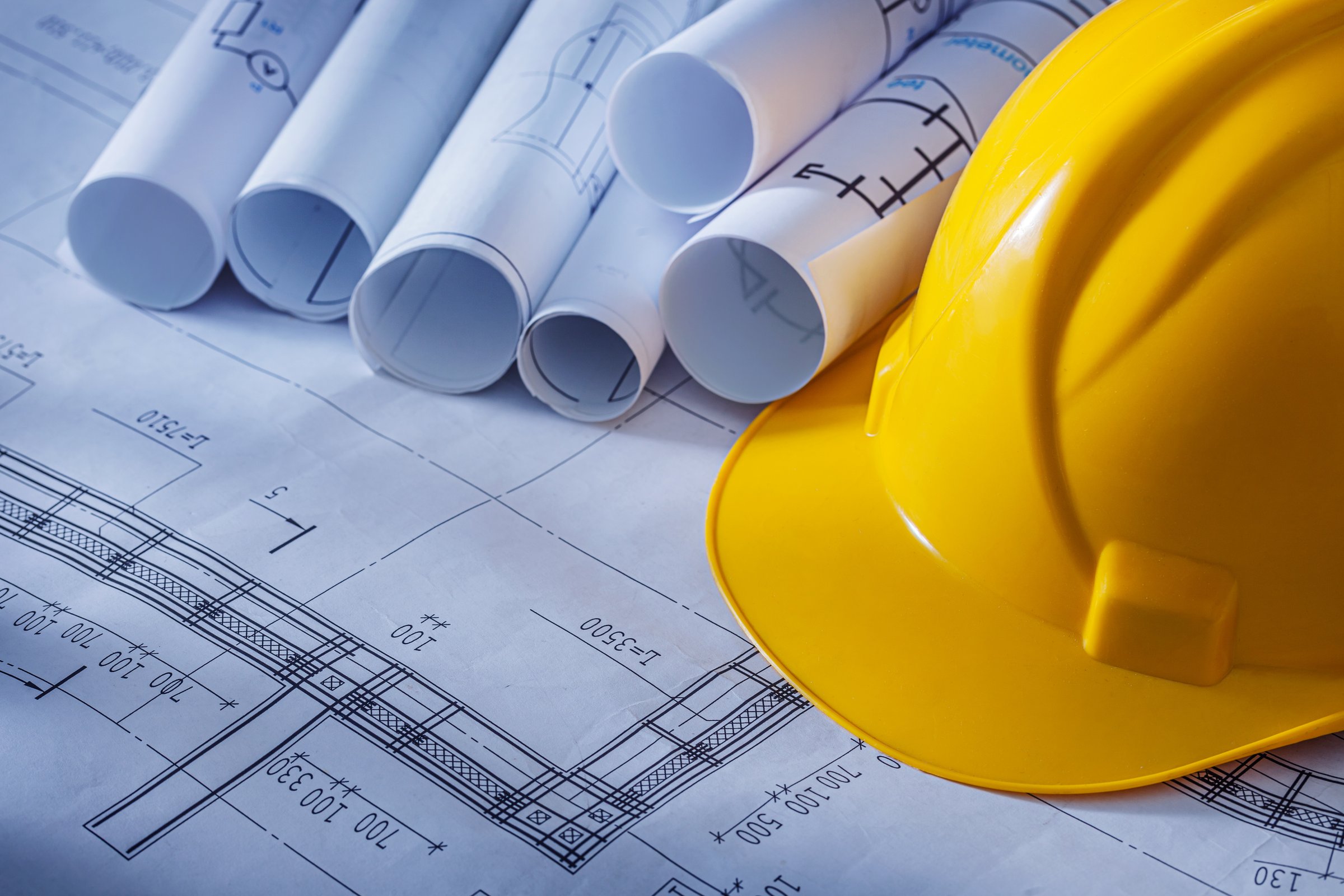 Architectural blueprints carefully rolled and prepared for precise delivery