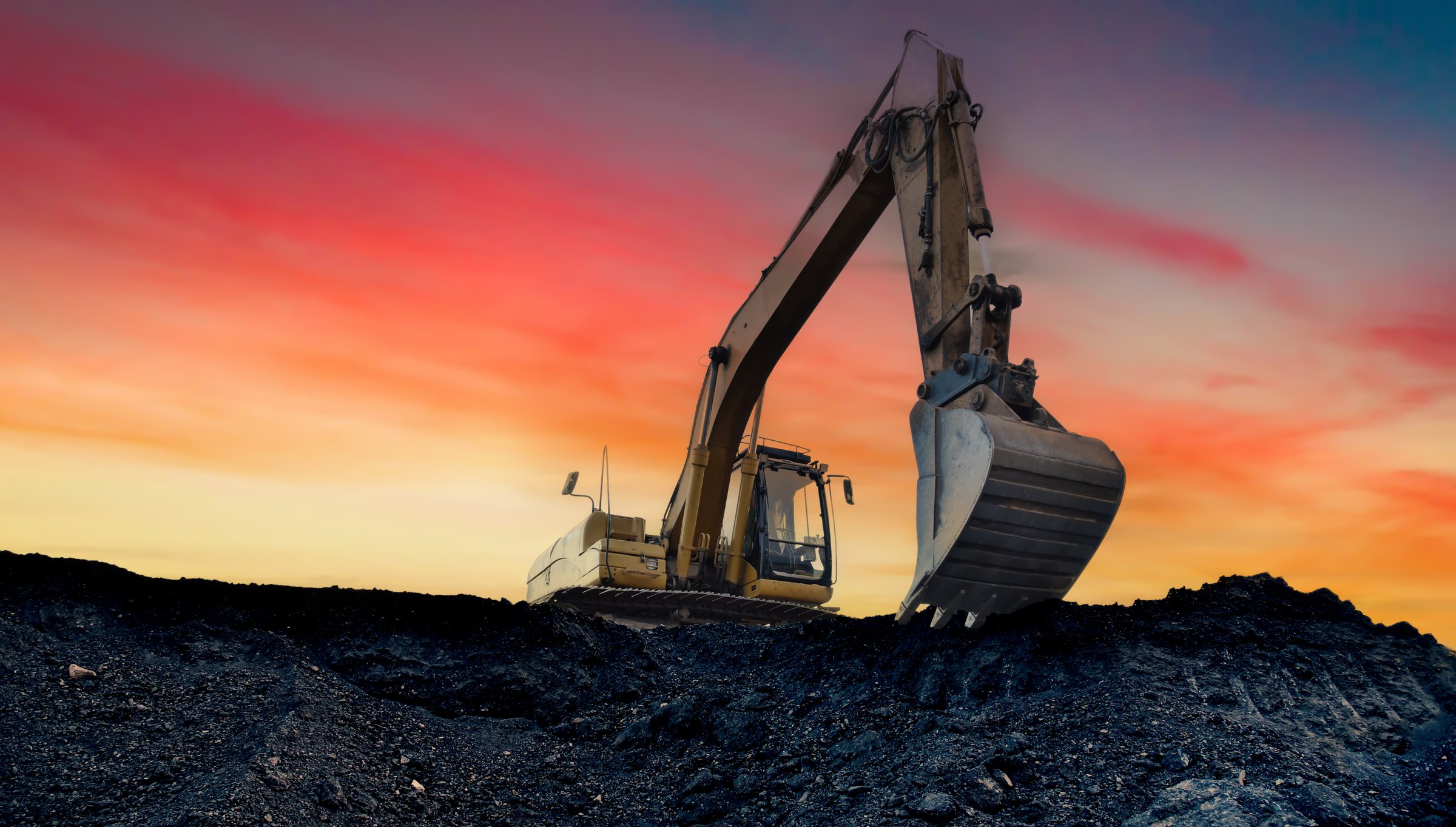 Coal mining in an open-pit. Excavator on Coal mining. Excavator digging in open pit coal mine. Excavator in open-pit on sunset background. Heavy machinery in opencast. Earthmover on earthmoving