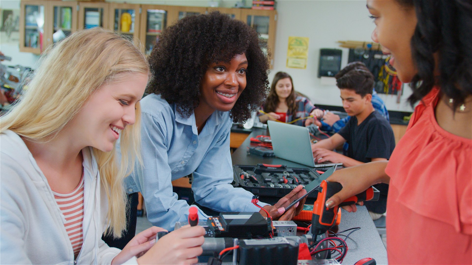 High School College Or University Teacher With Female Pupils Make Robotic Vehicle In Science Lesson