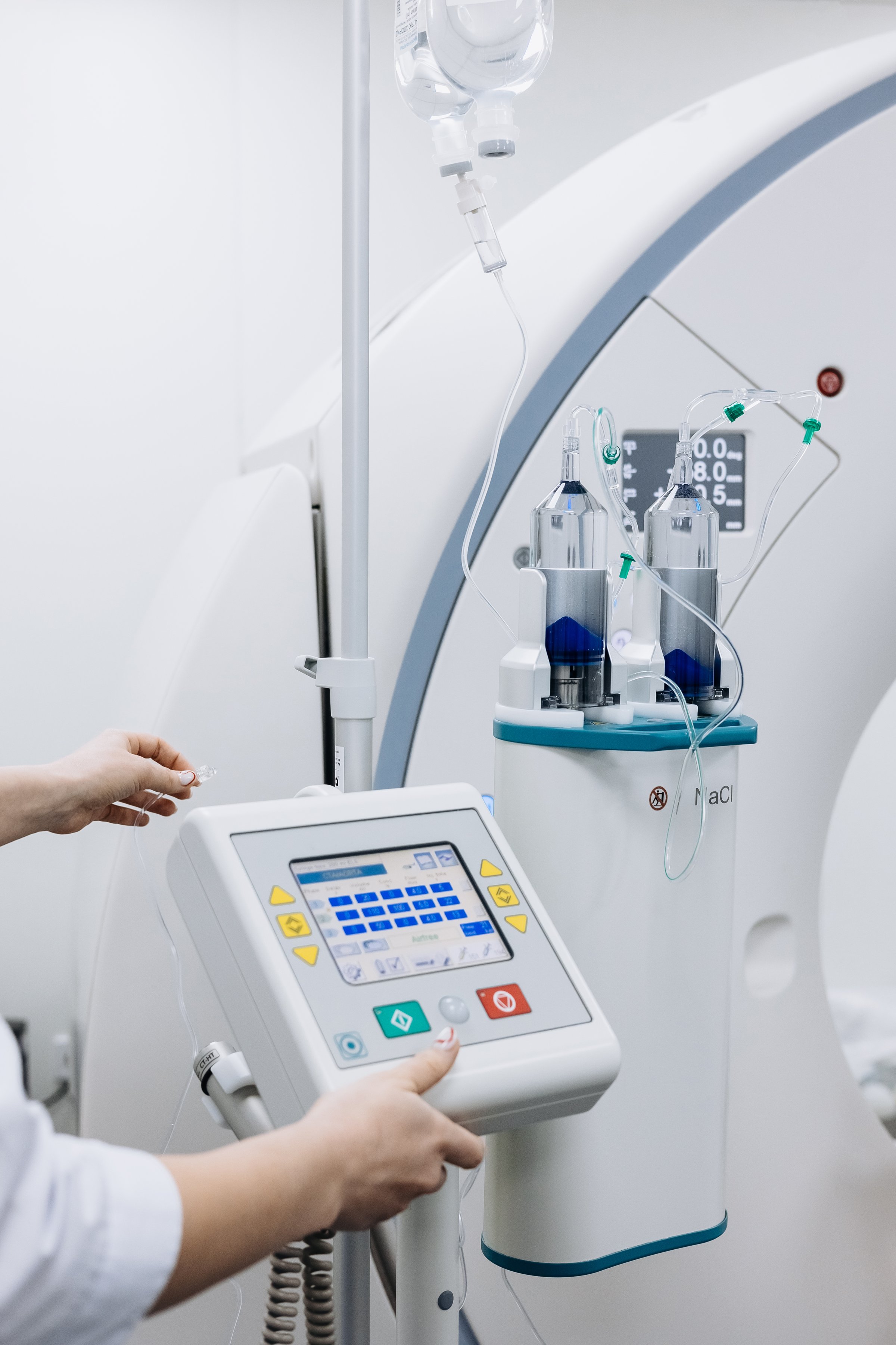 Contrast agent and CT scanner before diagnostics in the room. The concept of using modern technologies for accurate vascular examinations and disease diagnostics.