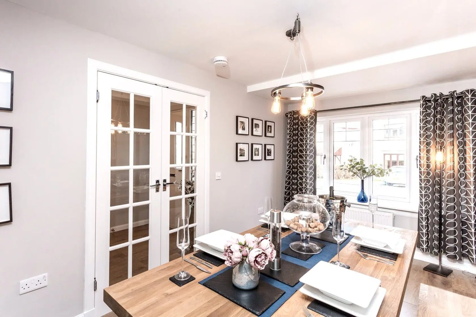 Bright, airy kitchen features new white cabinets hardwood flooring