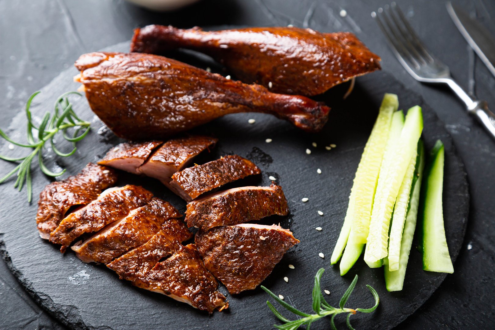 Peking duck with sauce on a dark table