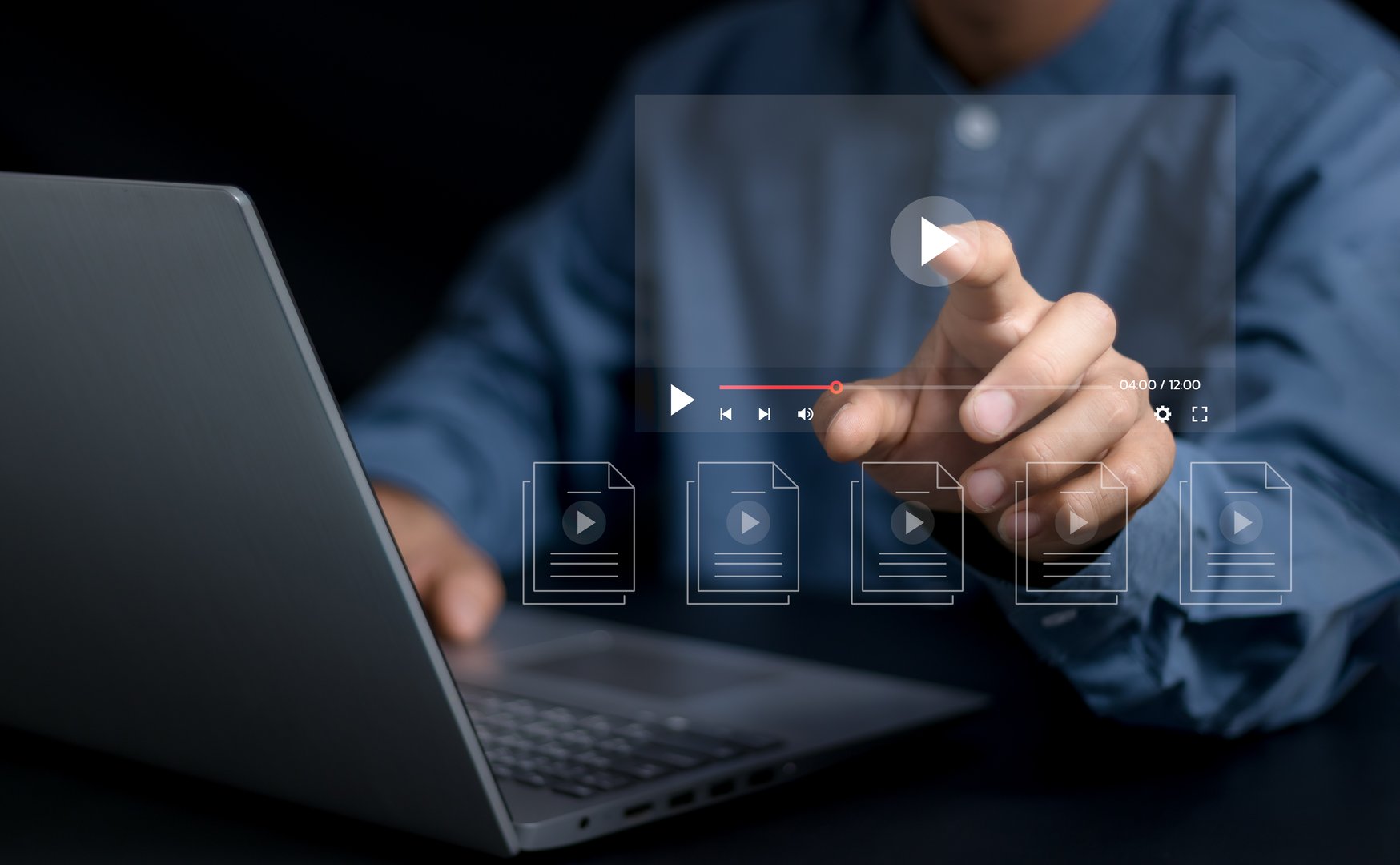Man using pressing the play button to start online entertainment for an online video-on-demand streaming service over the internet that includes movies or music.