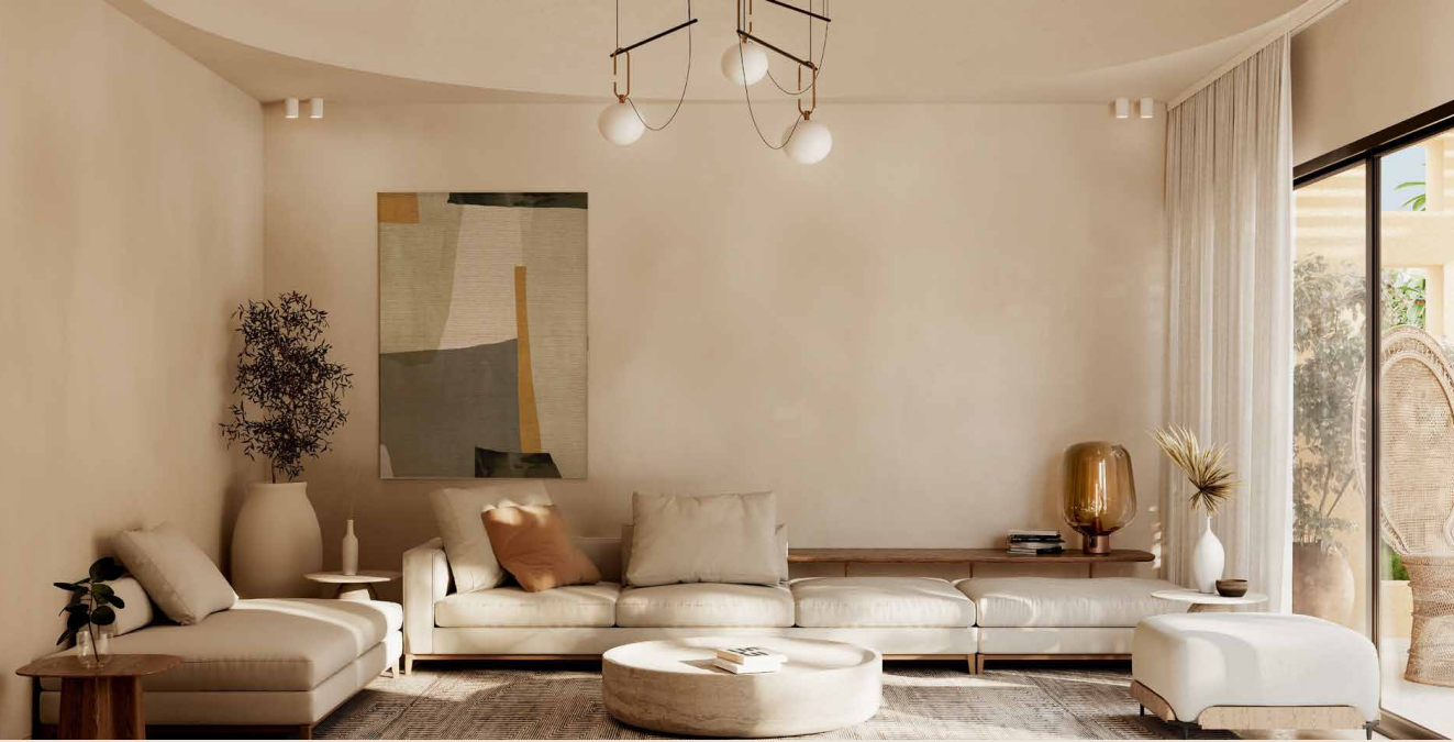 Minimalist living room with beige sofa, abstract art, round coffee table, and modern chandelier.