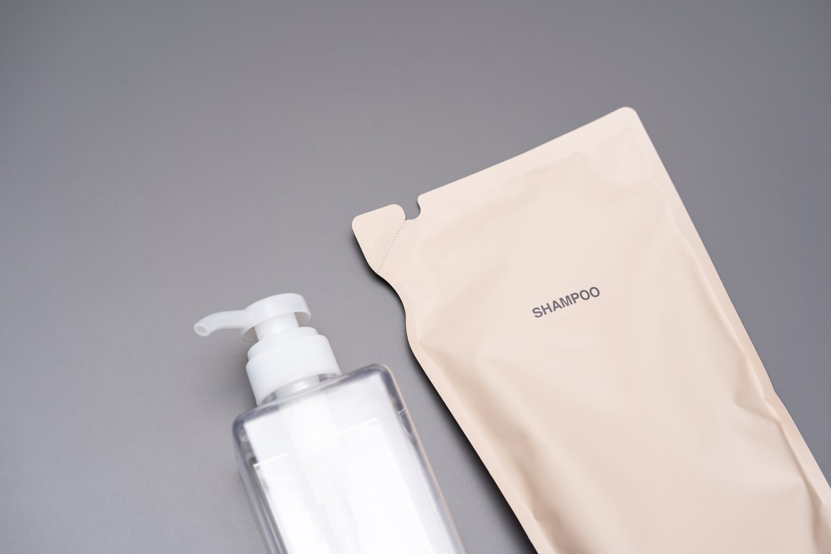 Refillable shampoo. Eco friendly package. plastic refill bottle on gray background.