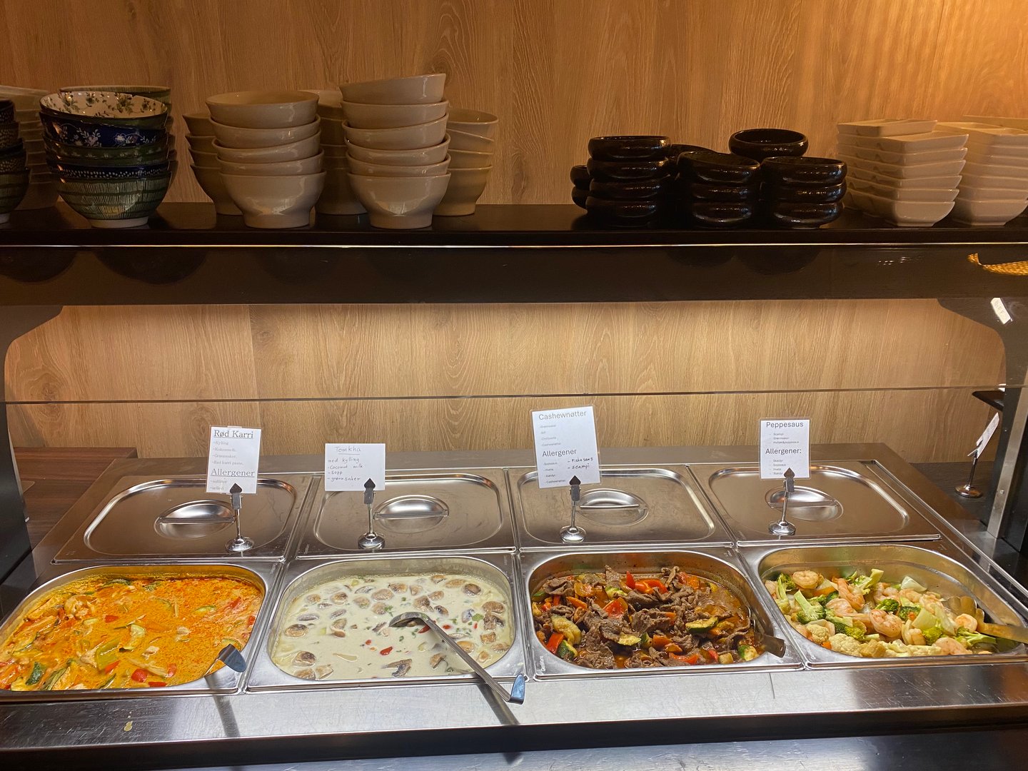 Close-up of a beautifully prepared salmon nigiri sushi garnished with green onion and truffle