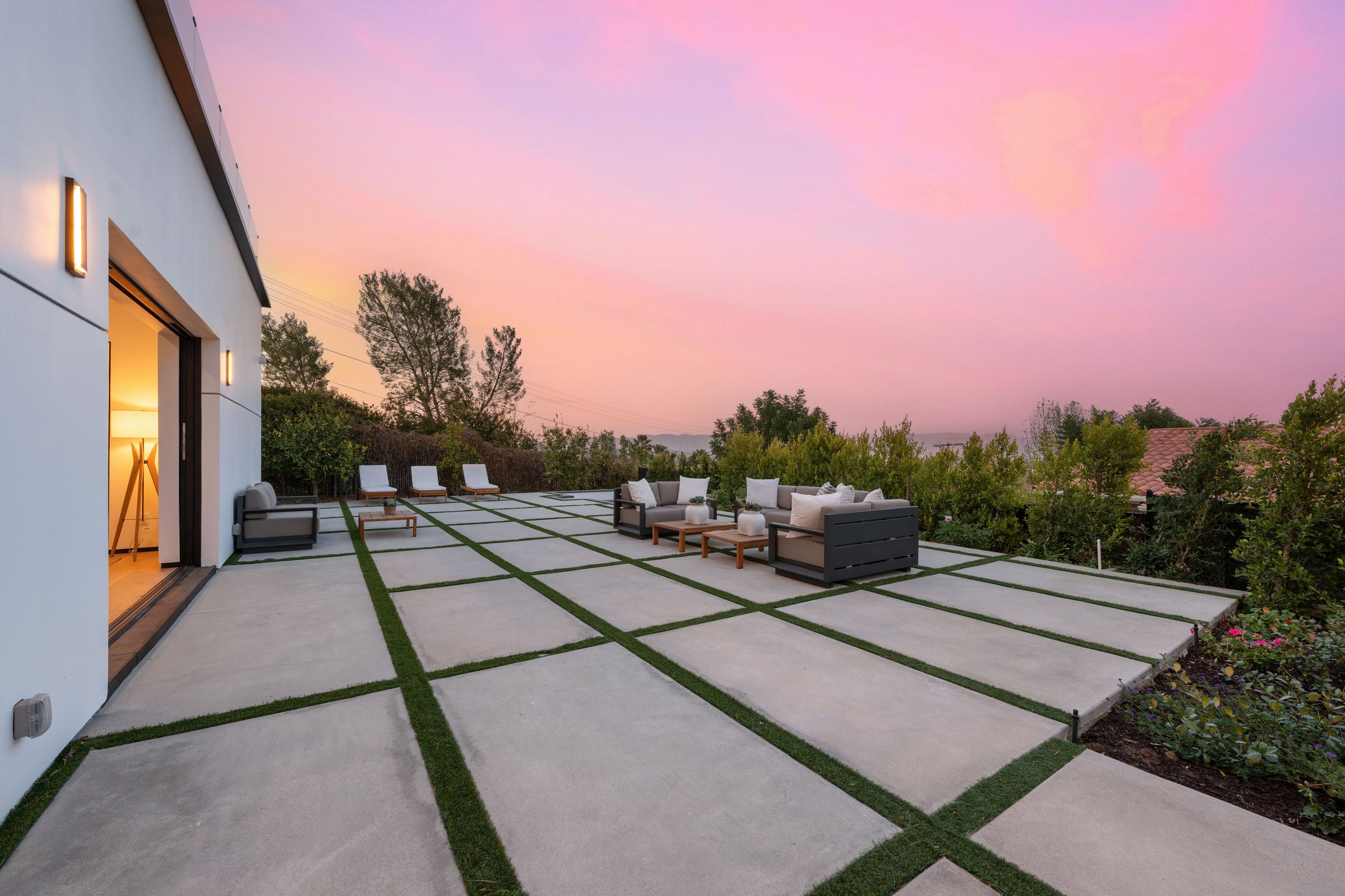 Elegant outdoor patio with stylish furniture, a private pool, and sunset views, perfect for relaxation and entertainment