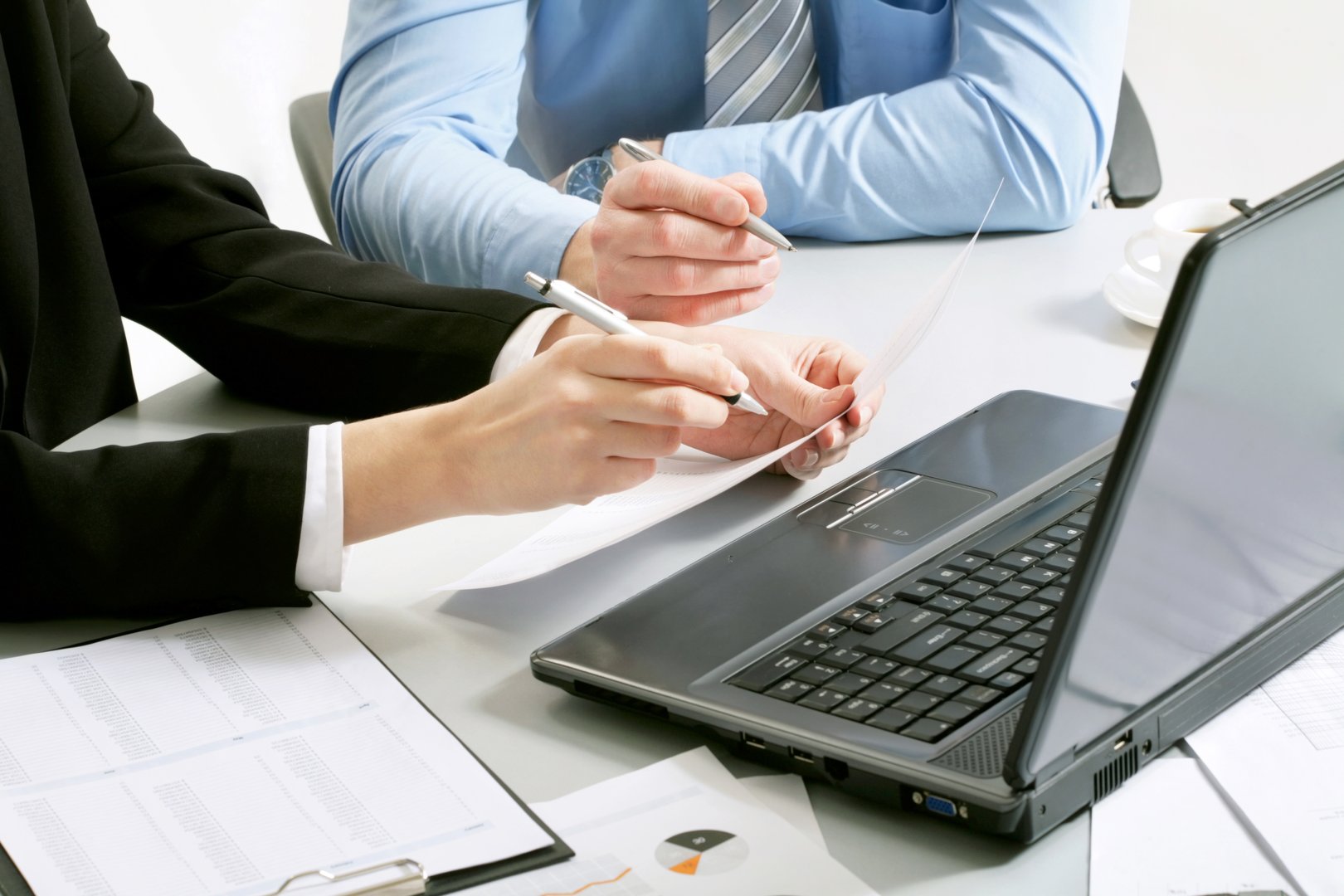Close-up of businessman explaining a financial plan to colleagues at meeting