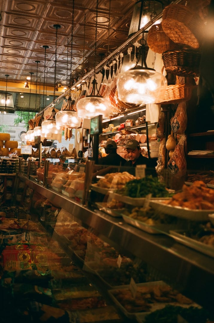 New York, United States – July 28, 2024: A popular and stylish Italian deli called Milano in New York wth hanging lights, vertical shot