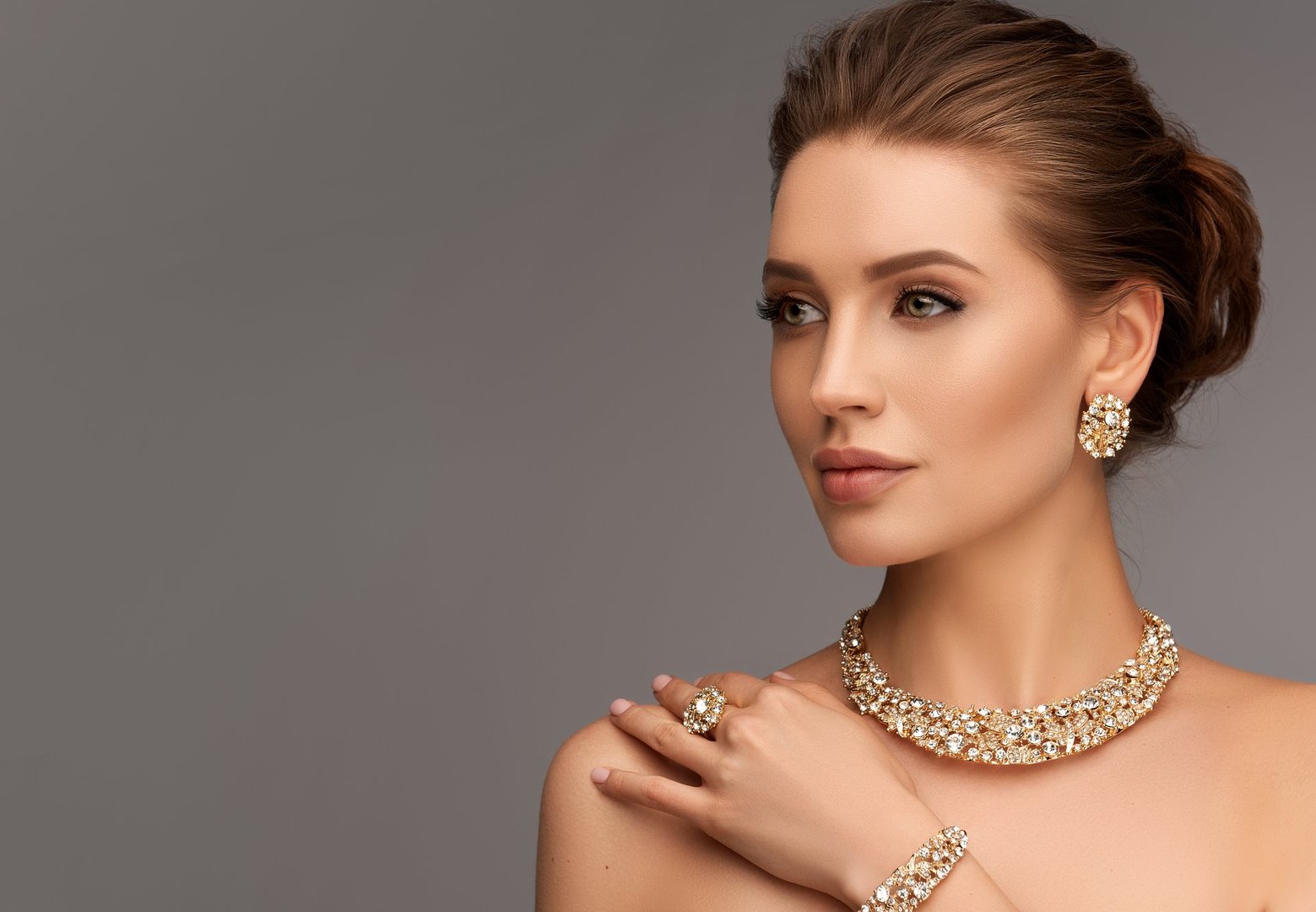 Elegant woman wearing luxury gold and silver jewelry