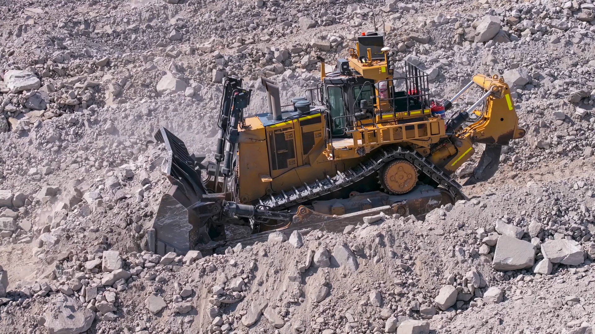 Giant bulldozer in the process of forming platforms with fill material in mine dump