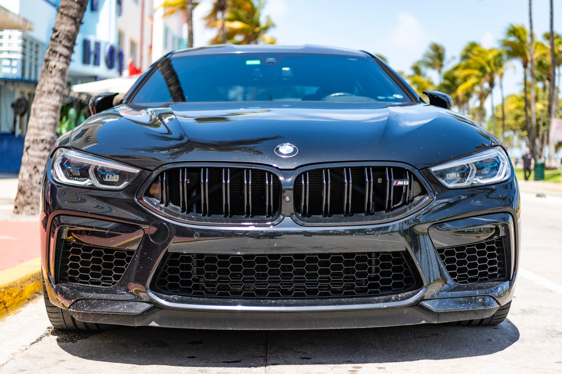 Miami, Florida, USA - April 02, 2025: Car BMW M8 coupe parked outdoor. Black coupe car, front view. BMW M8 Gran Coupe car. Luxury coupe car BMW M8.