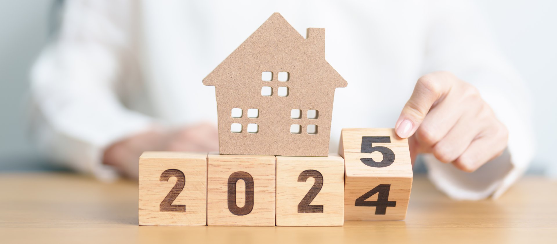 2024 end year to Happy New Year 2025 with house model. real estate, Home loan and mortgage, tax, investment, financial, savings and New Year Resolution concepts