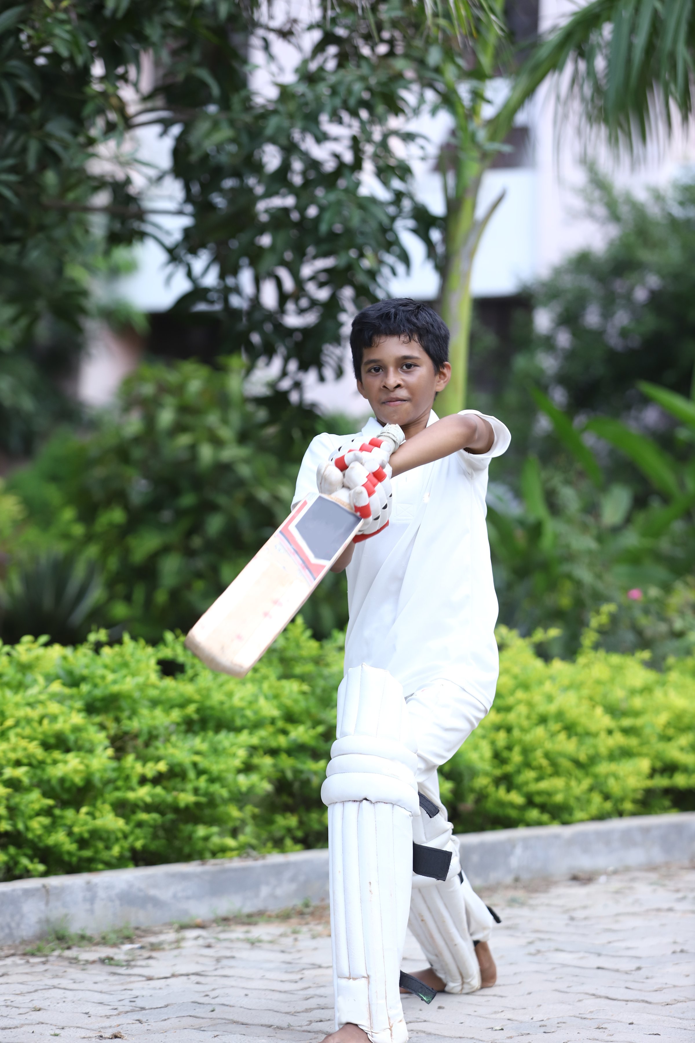 This Young Boy from India is Motivated to Perform Well to Earn his Place Supporting his Favorite Cricket Team.  He is dressed in his Team Uniform and Ready for Action!