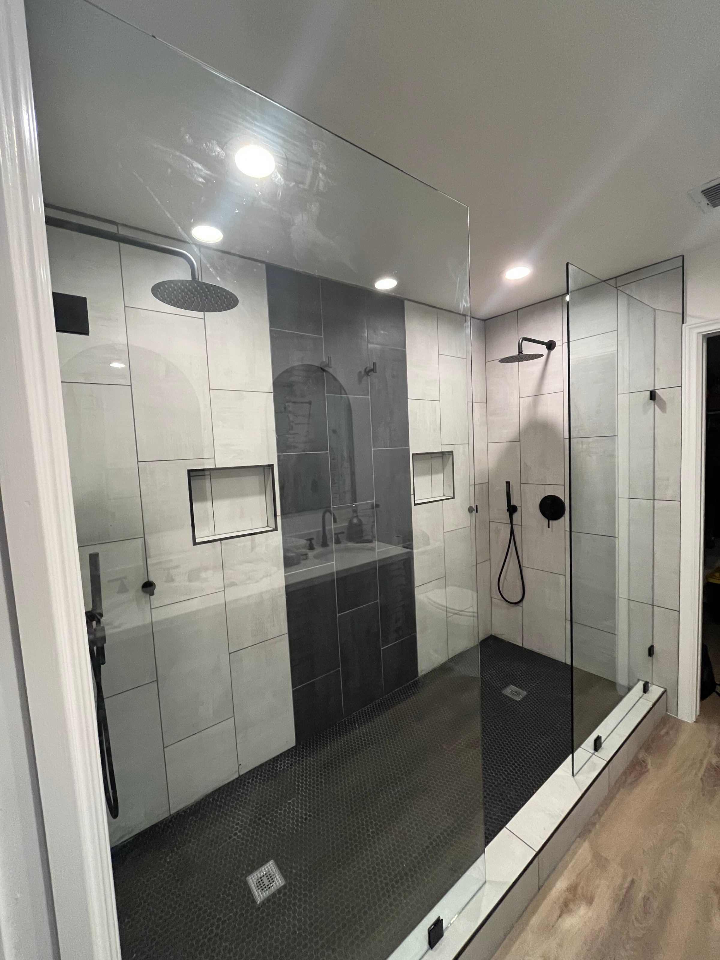 Modern bathroom renovation featuring custom tile work and contemporary fixtures by Cole's Remodeling