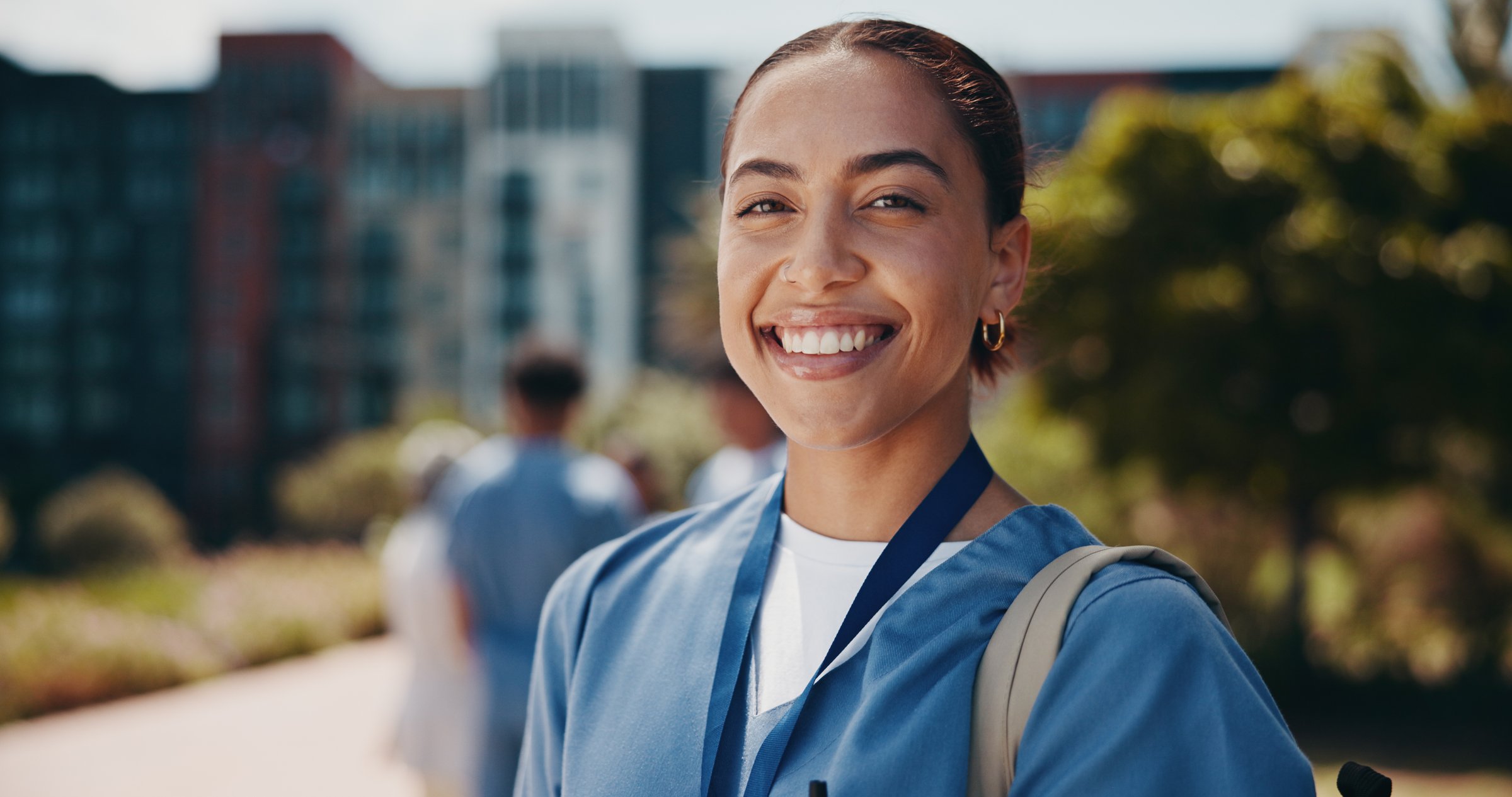 Portrait, doctor or woman in medicine outdoor for health training program, healthcare study or hospital residency. Medical school, student or smile with learning backpack on campus for nursing career
