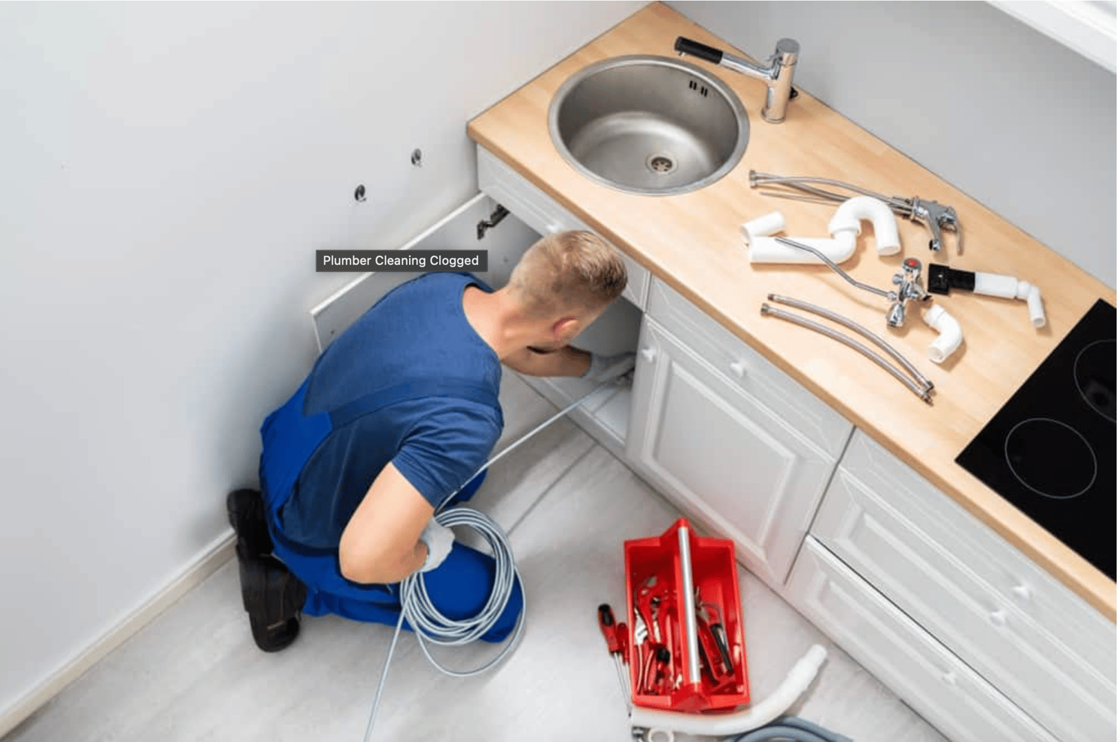 Plumber clearing blocked drain