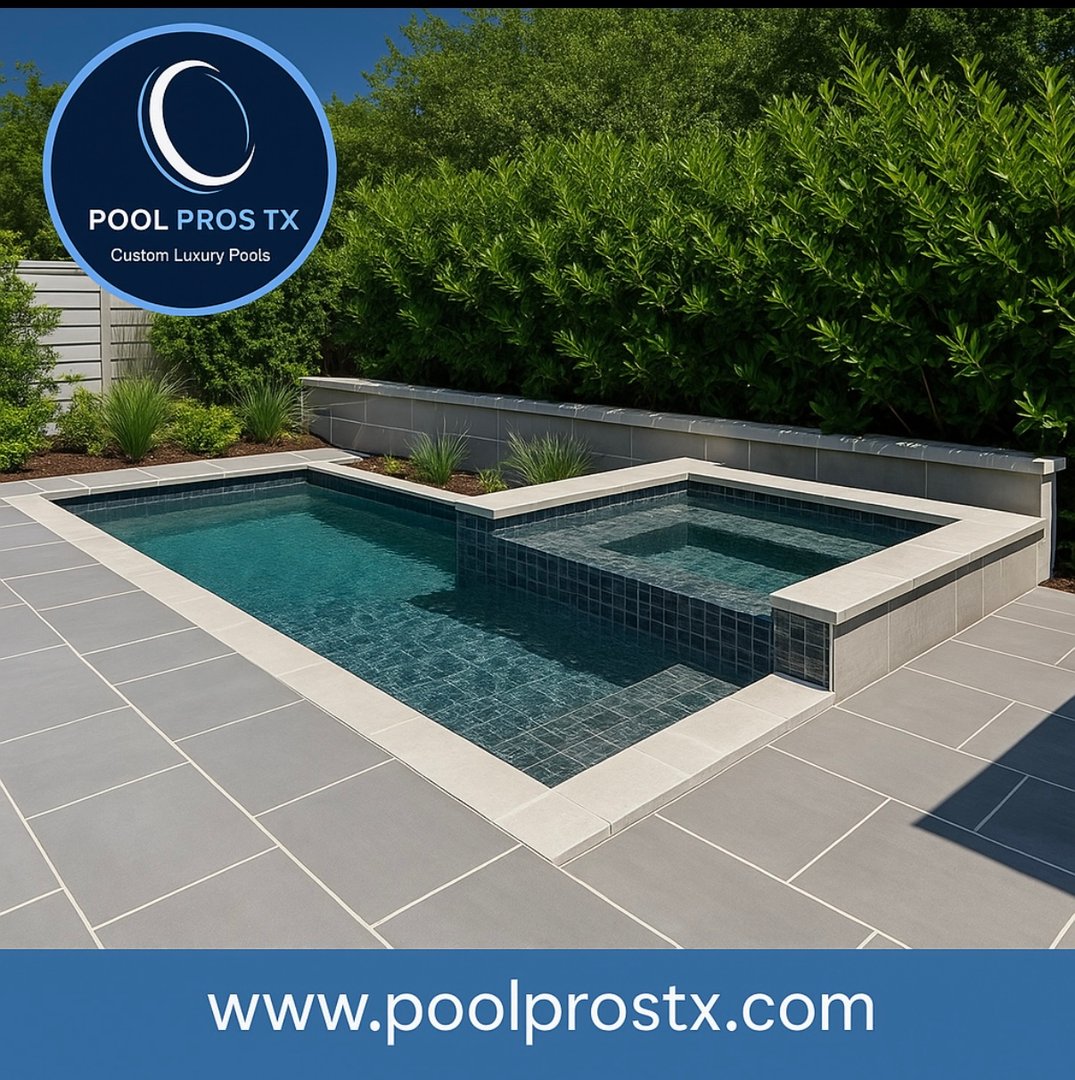 Modern outdoor pool with a separate spa area surrounded by gray tiles and lush greenery, featuring Pool Pros TX logo and website.