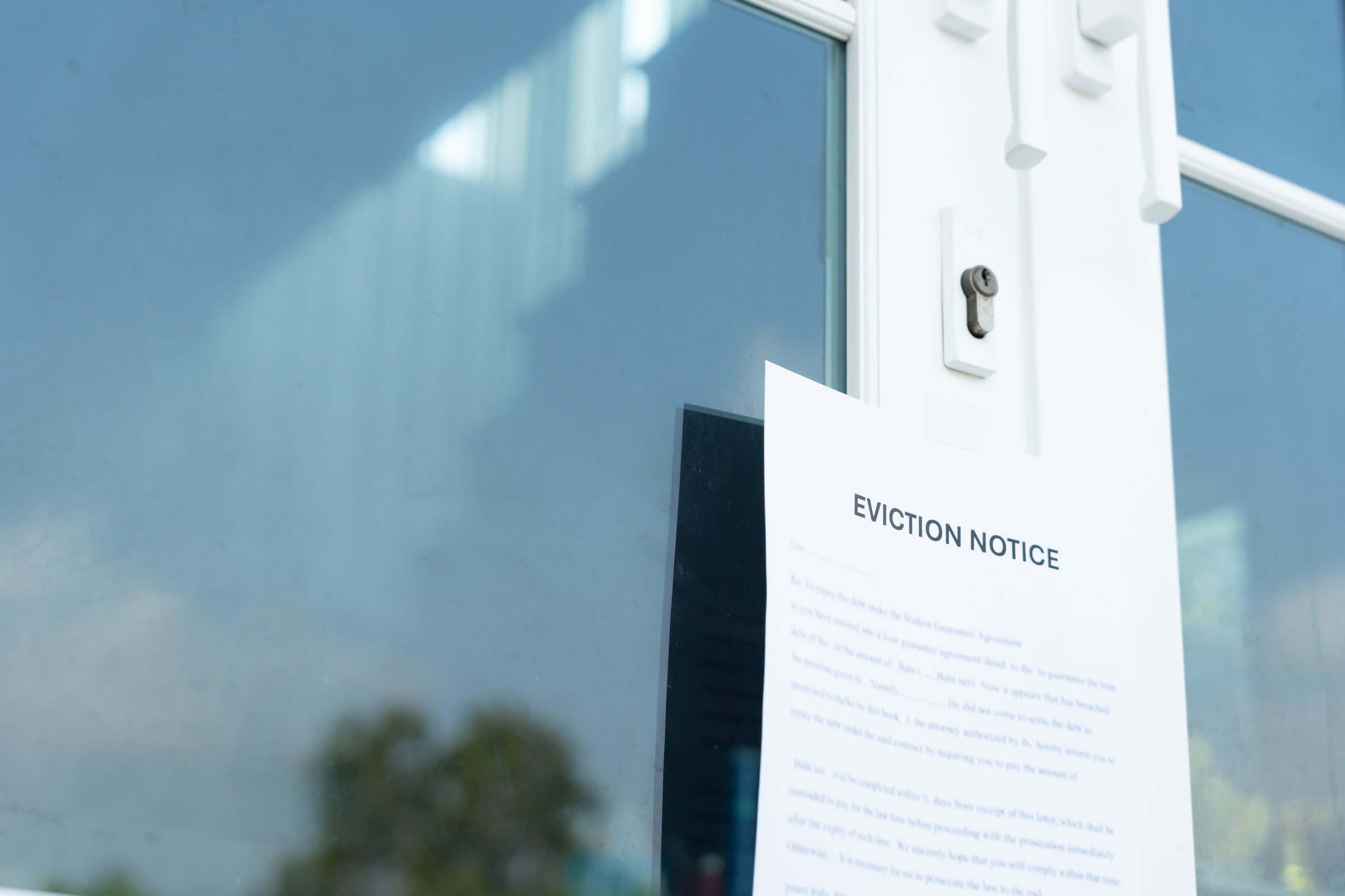 document with the text eviction notice, Civil servant sticks a notice of eviction of the tenants hangs on the door of the house, debt, property, loan, agent, bankruptcy, dispossess, problem