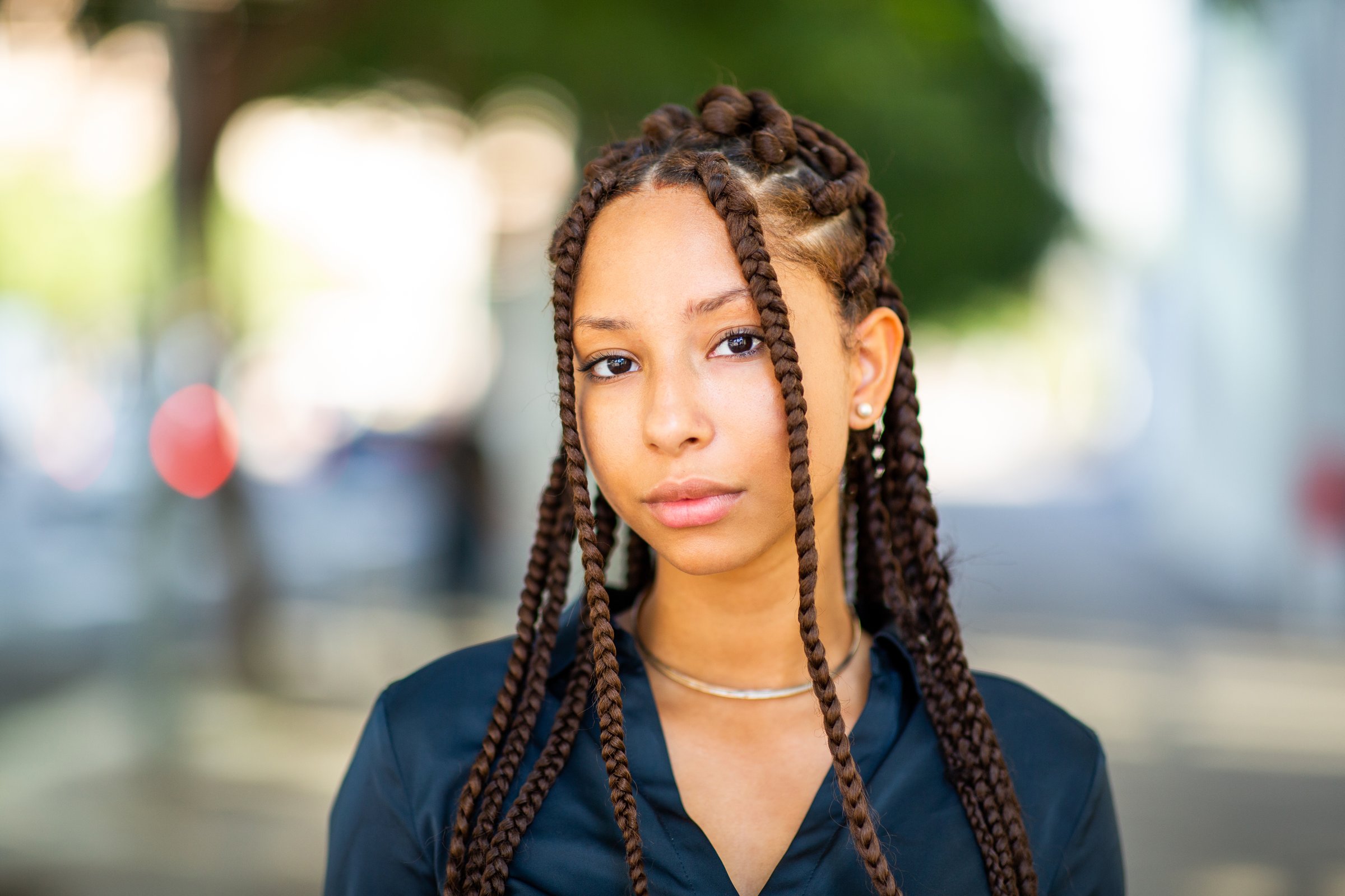 Close up portrait of confident young african american female with braided hairstyle