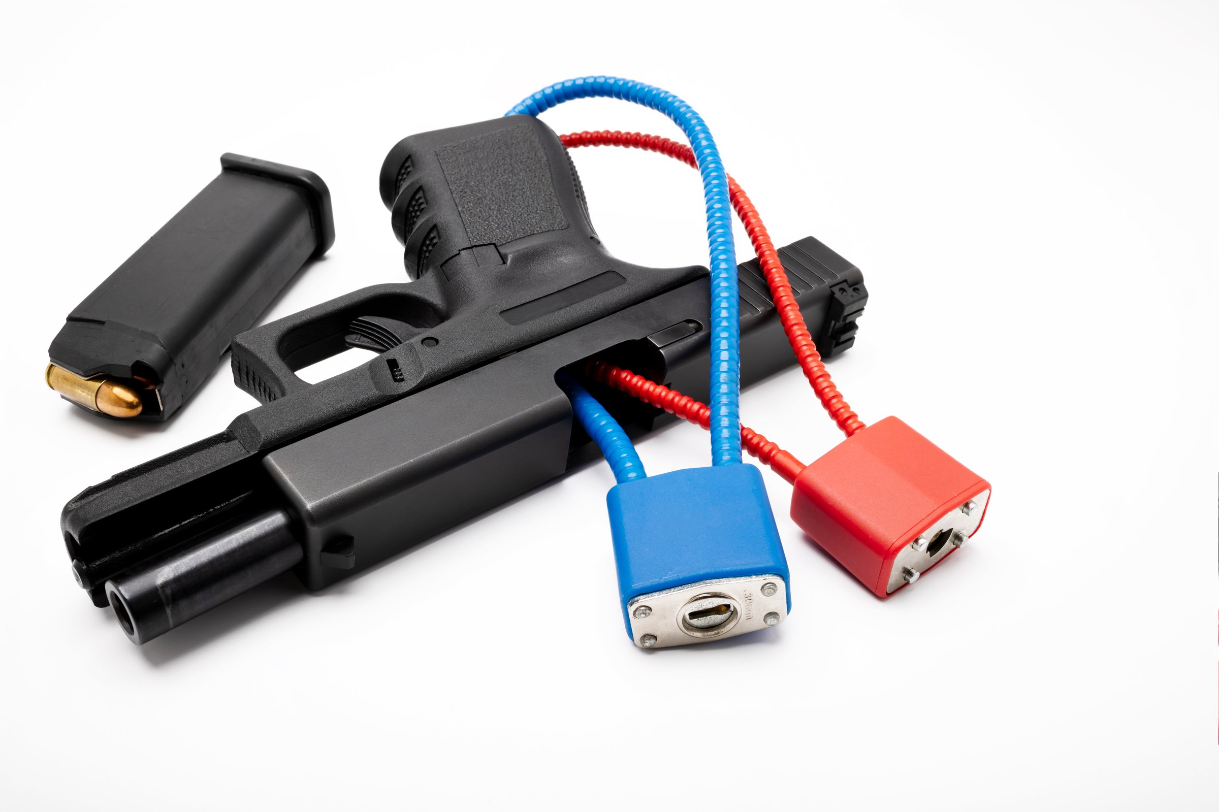 A cable lock keys secures a pistol from having the magazine inserted and keeping the slide from fully closing , Gun safety concept