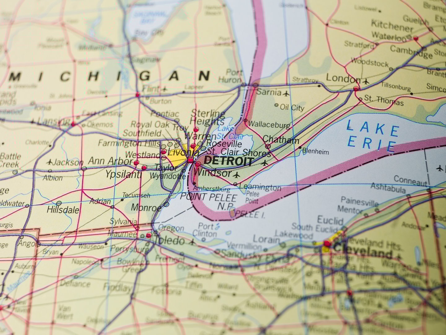 Close-up of a map showing Detroit, Michigan, Lake Erie, and surrounding cities in the United States and Canada.
