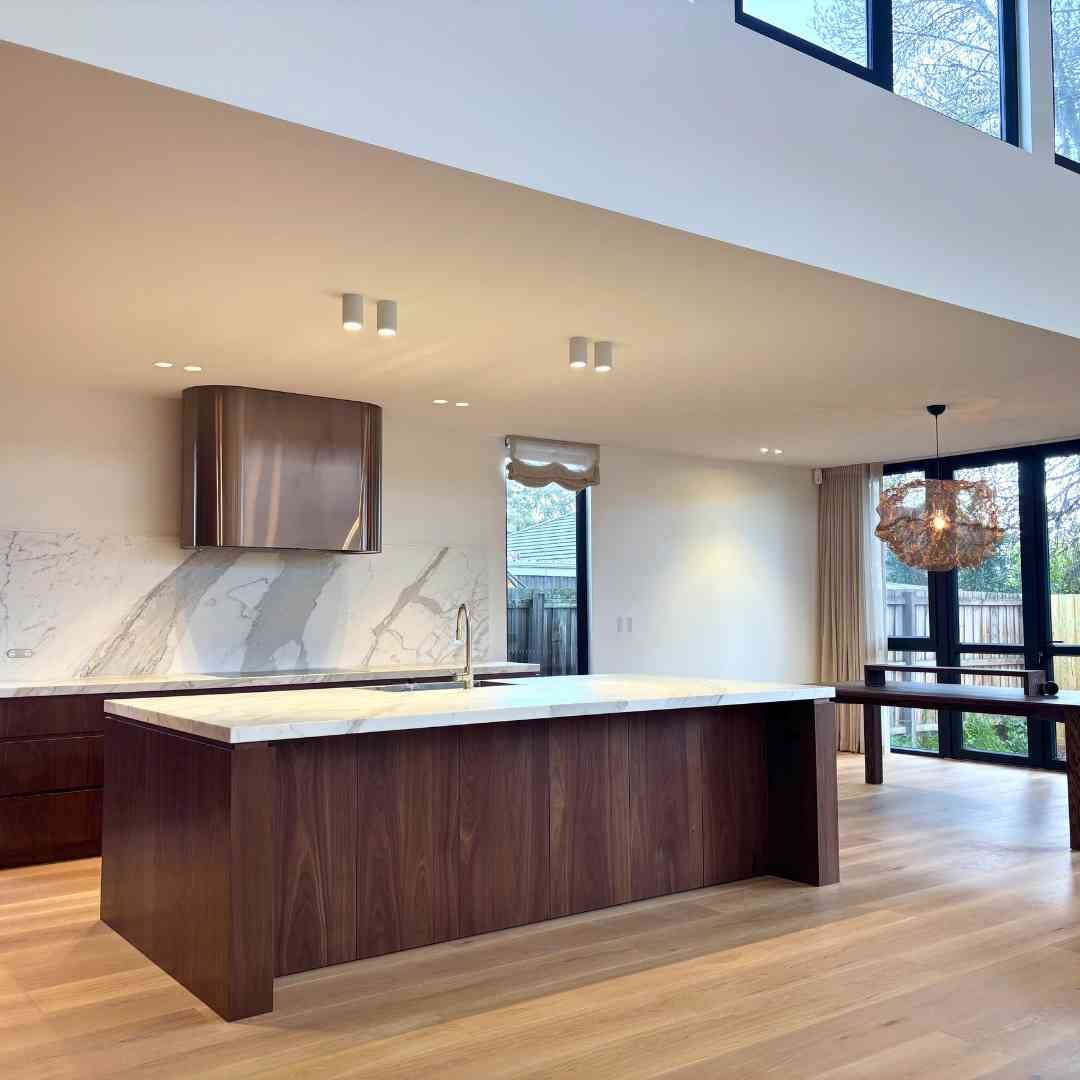 Minimalist kitchen detail showing American Oak cabinetry and stone benchtops