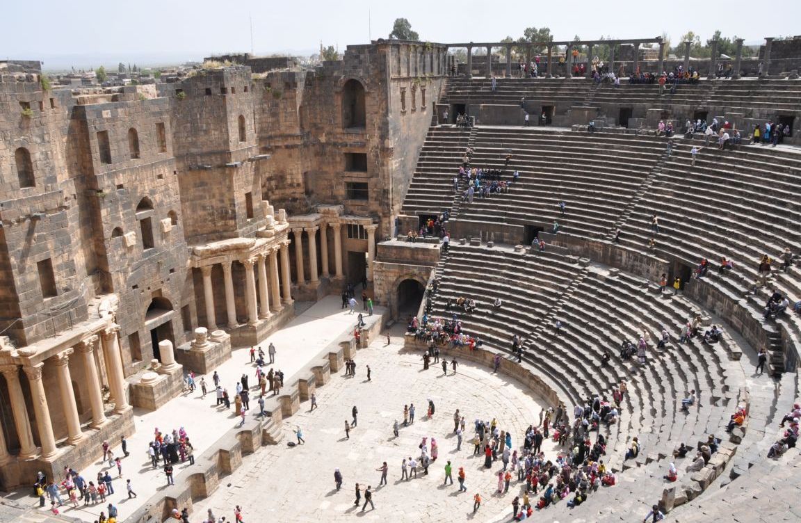Ancient Roman theatre and ruins of Bosra, Syria, showcasing the black basalt stone architecture