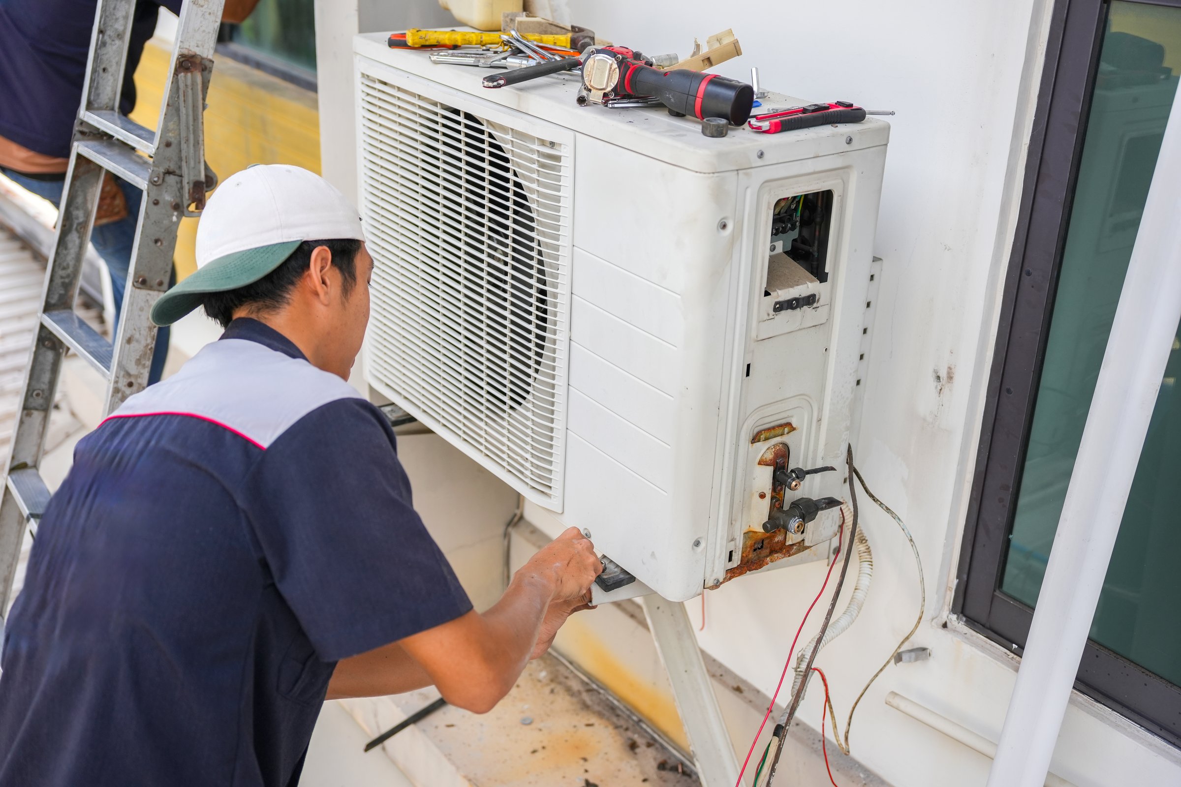 Technician man service team repair and maintenance of air conditioners, Repairman fix air conditioning systems, Air conditioning technicians install new air conditioners