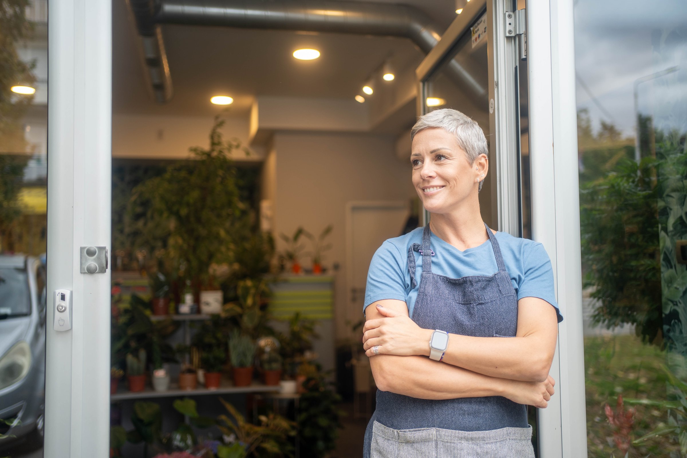 Portrait of a mature florist running her flower shop.