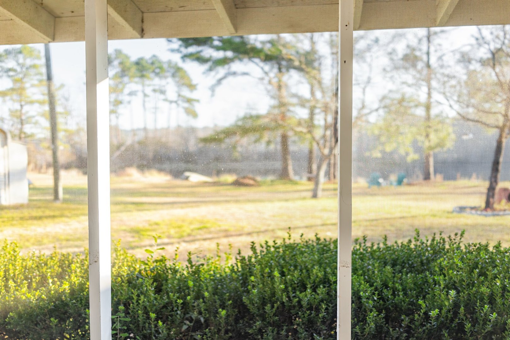 South Carolina sunset near Lake Marion with back porch and mesh screen landscape view in spring evening sunset with nobody