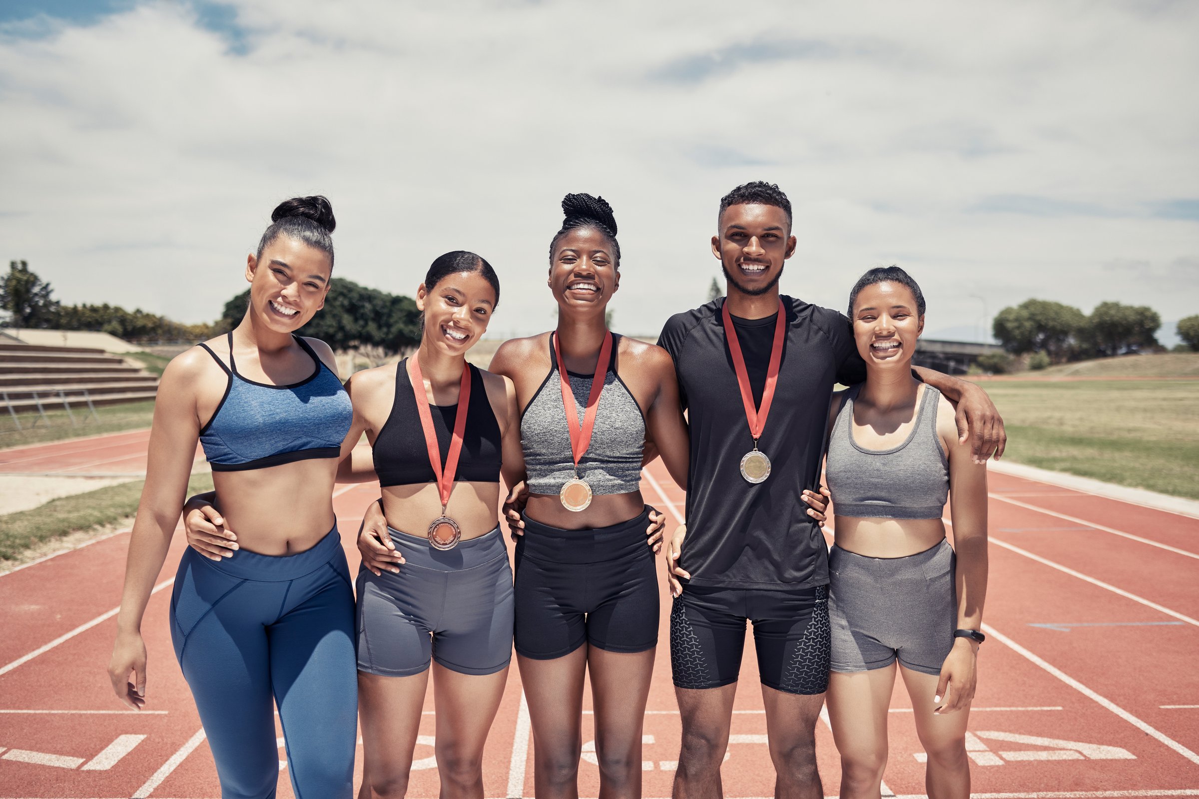 Portrait, diversity and team for sports success, for competition and smile together for results outdoor. Teamwork, fitness training and medals for games, winners or victory embrace, happy or on track