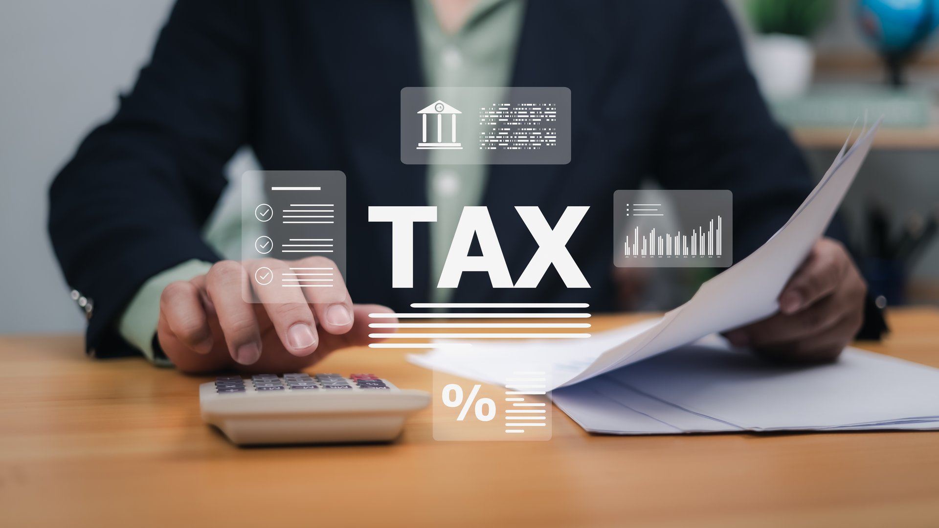 Hands interacting with digital tax interface, calculator, documents. Symbolizes tax system, financial management, online accounting. Ideal for tax preparation, business finance, legal compliance now.