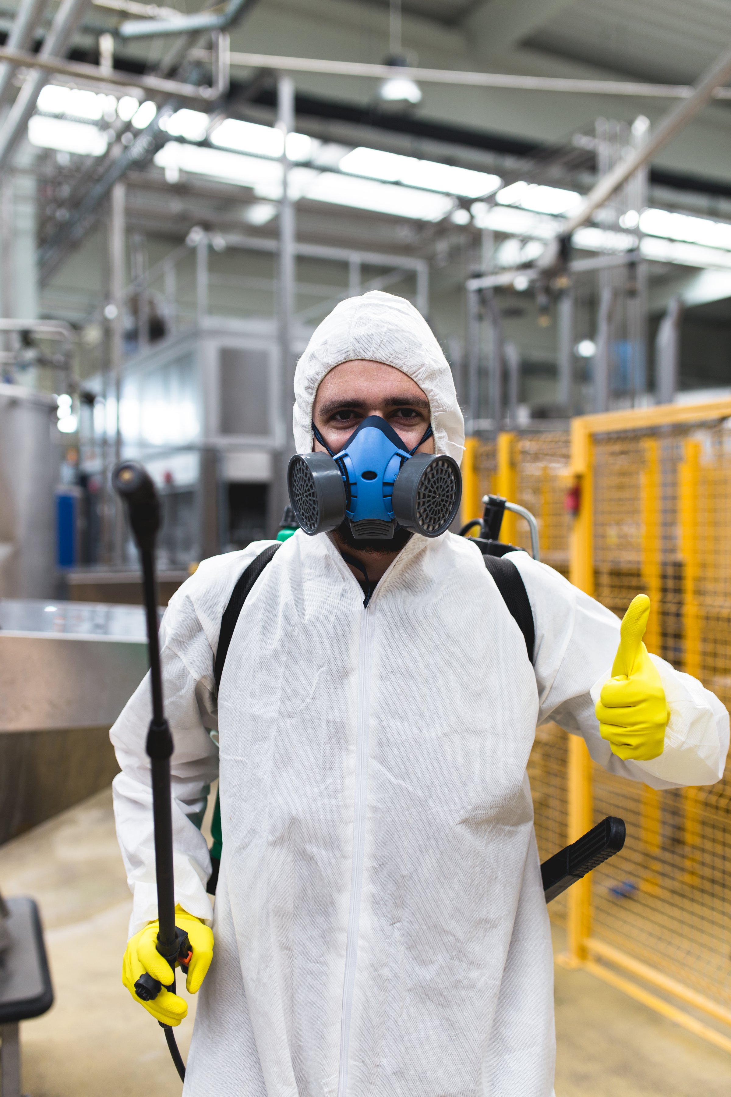 Pest Control Worker Hand Holding Sprayer For Spraying Pesticides in production or manufacturing factory