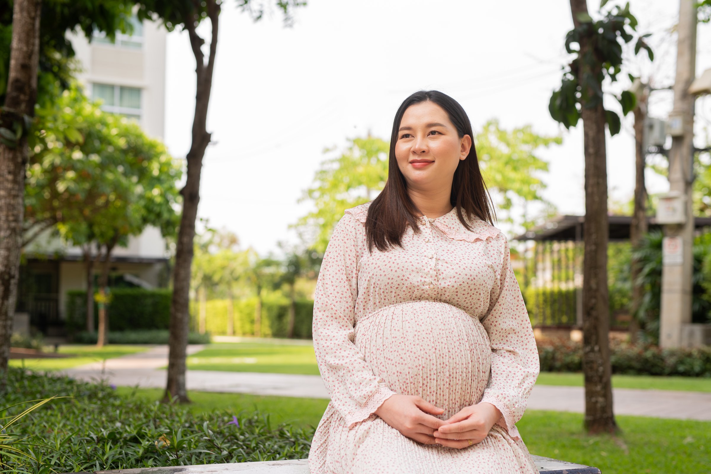 Pregnant Asian woman portrait outdoors