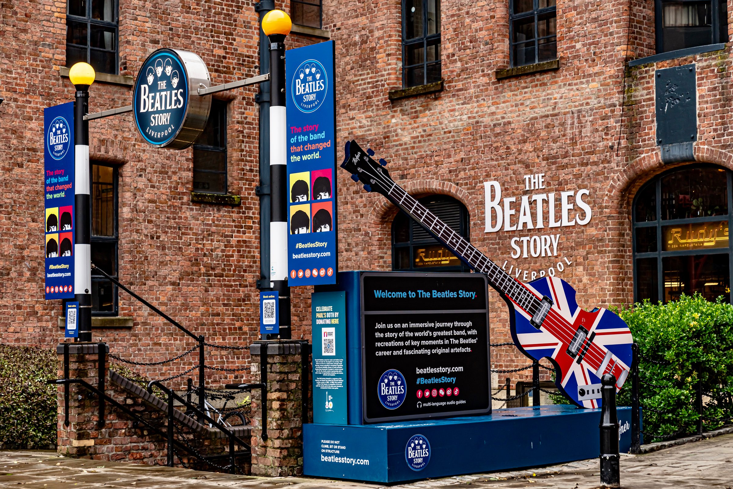 Liverpool, England, UK - 05.23.2024
- The Entrance of the Beatles Museum at famous Royal Albert Dock in Liverpool, England on a very cloudy Spring Day