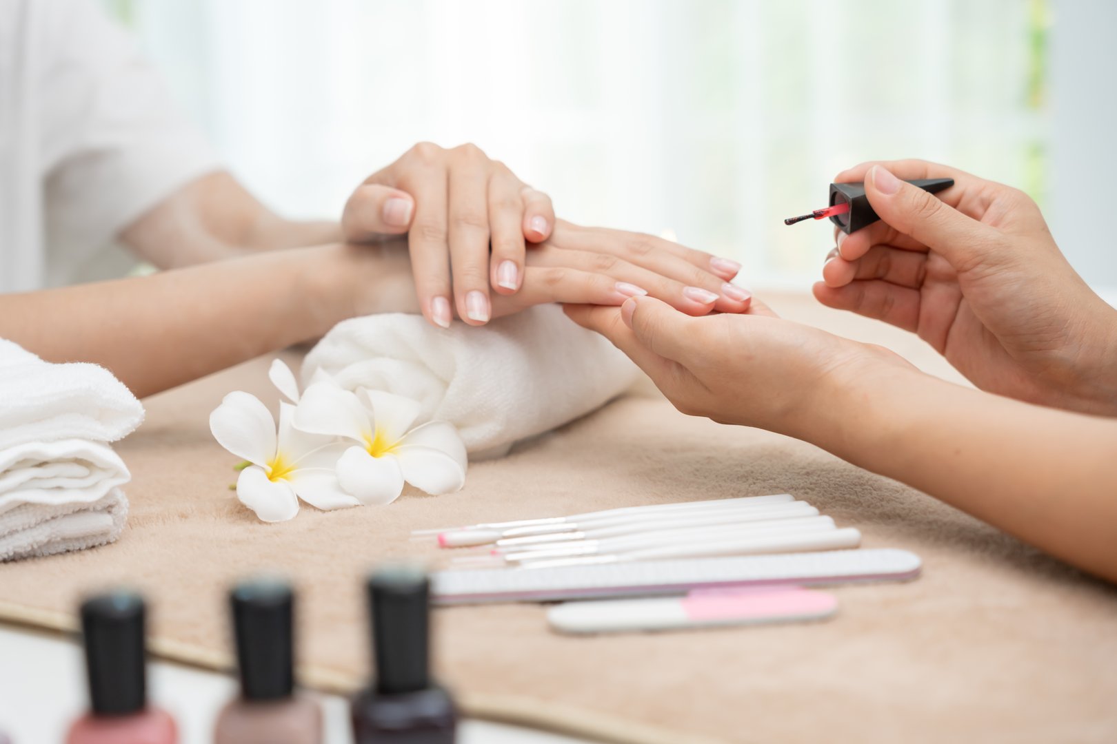 Woman receive care service by professional Beautician Manicure at spa centre. Nail beauty salon use nail file for Glazing treatment. manicurist make nail customer to beautiful. body care spa treatment