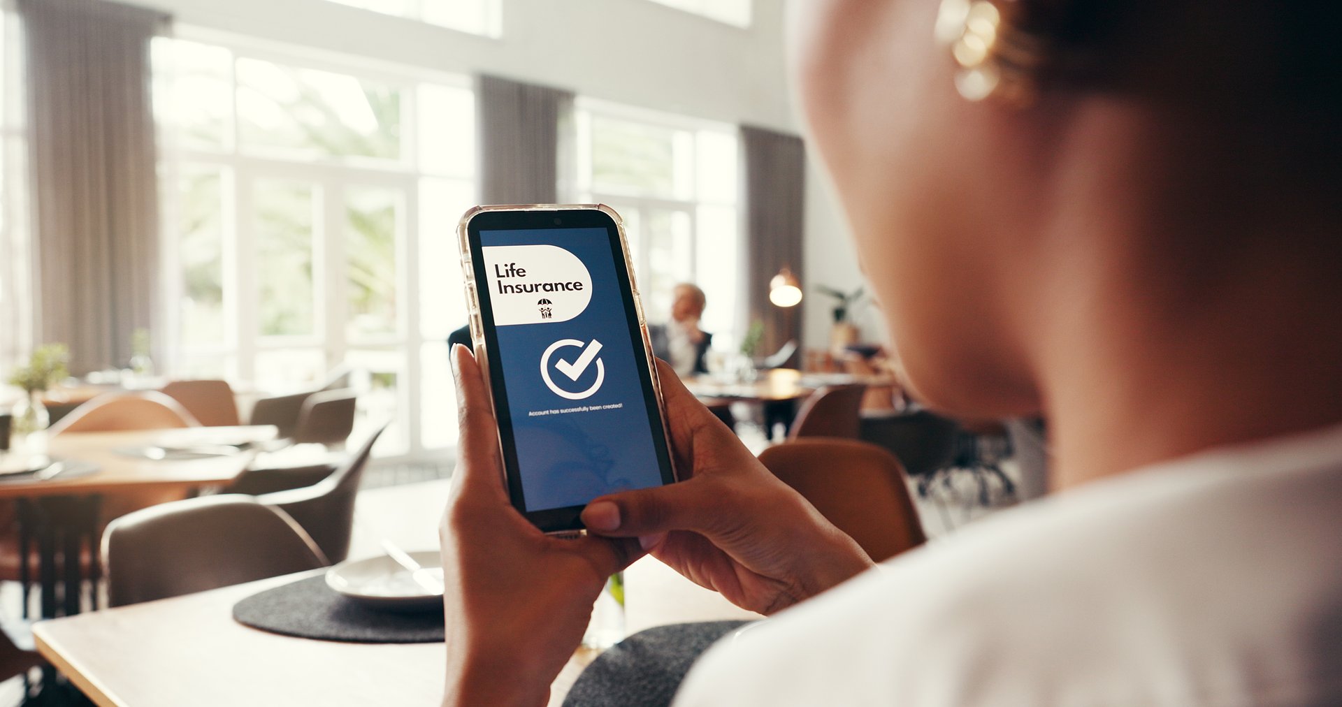 Phone screen, life insurance and hands of woman for digital application, app and sign up. Claims status, membership benefits and cover research with person for login and online review in cafe