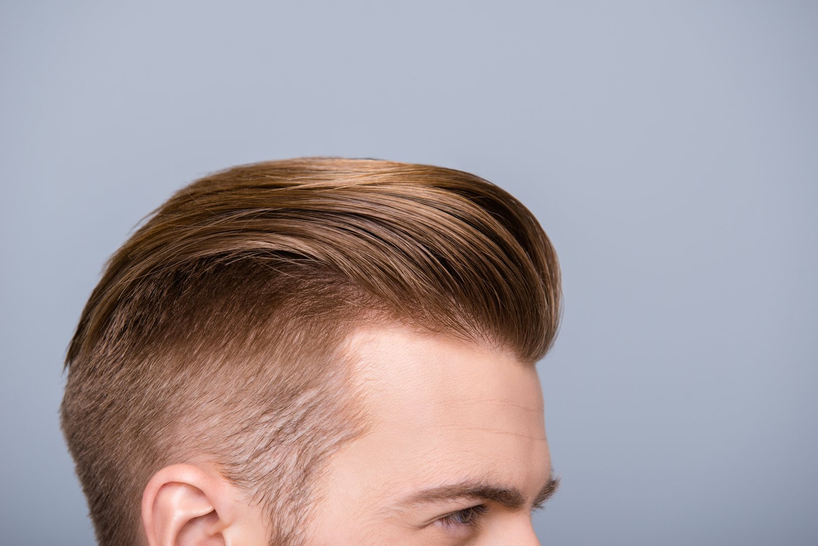 Cropped photo portrait of man's head with health hair and stylish haircut