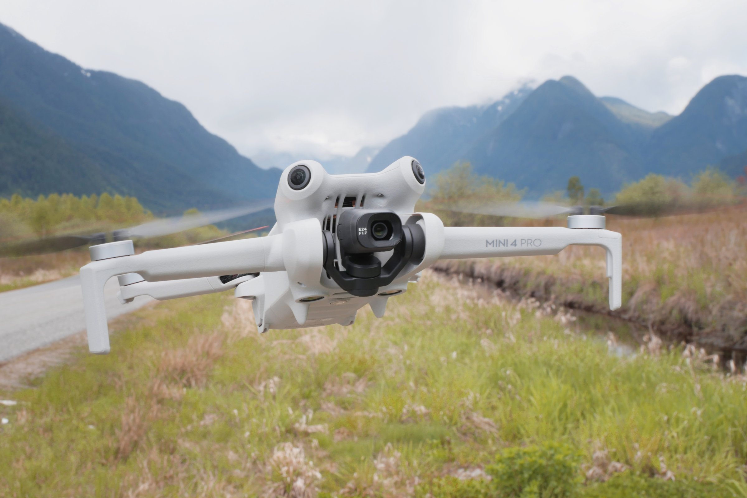 DJI Mini 4 Pro micro drone frontal view while hovering in midair on Rannie Road near Grant Narrows Regional Park in Pitt Meadows, British Columbia, Canada.