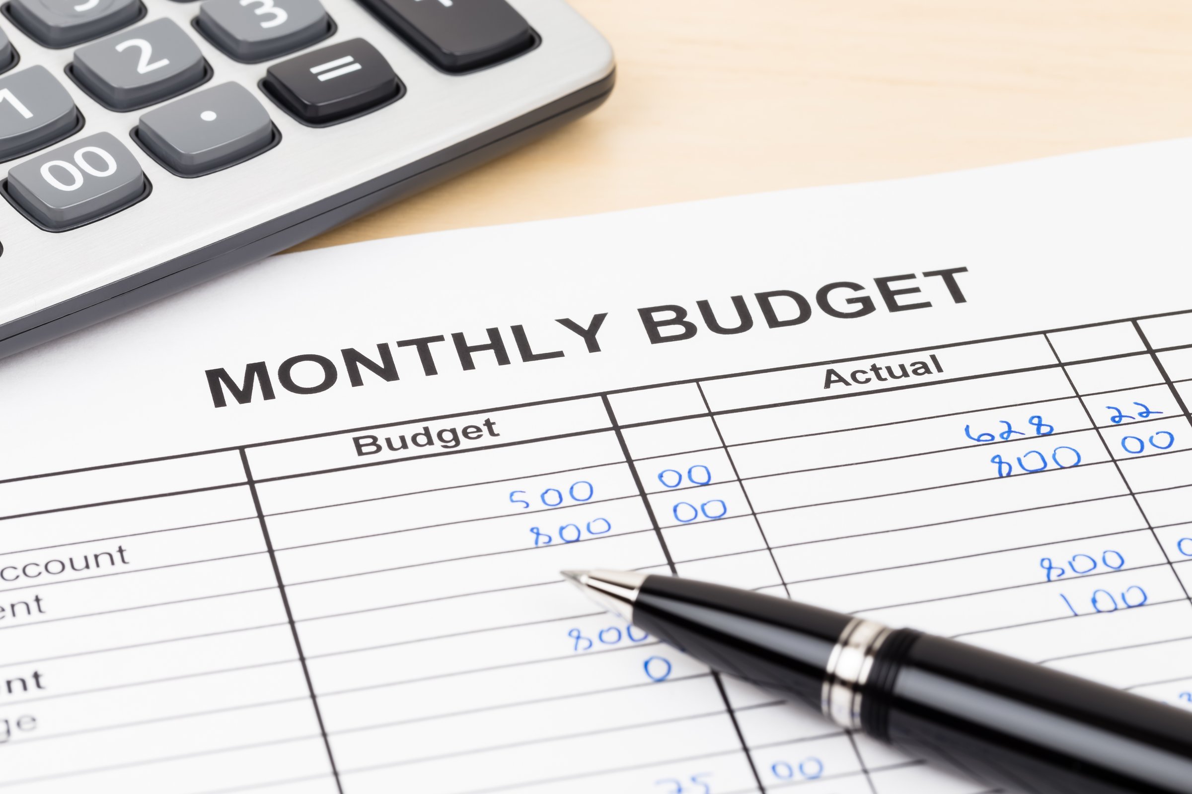 Home budget planning sheet with pen and calculator