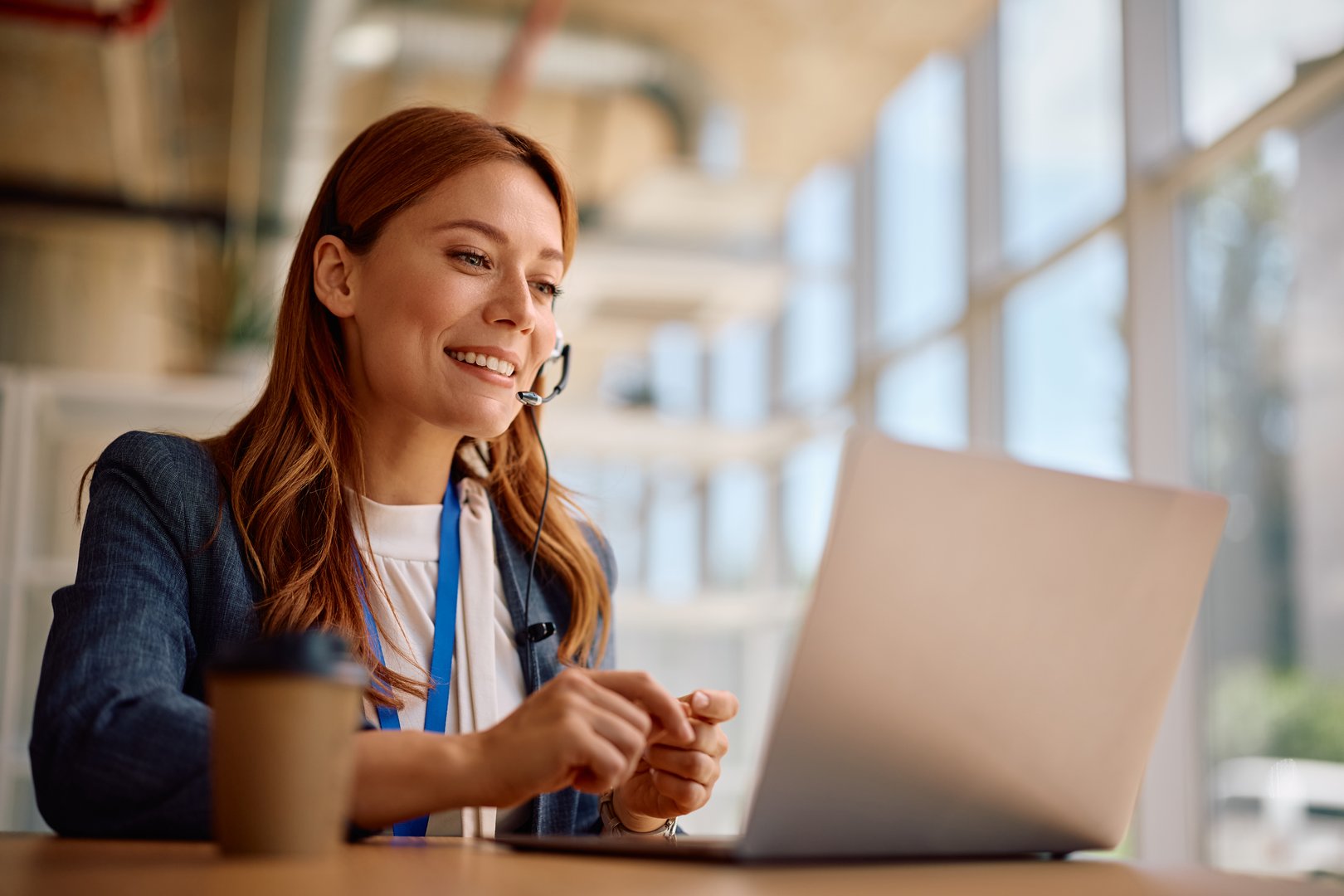 Smiling businesswoman having video call over laptop while working in the office.