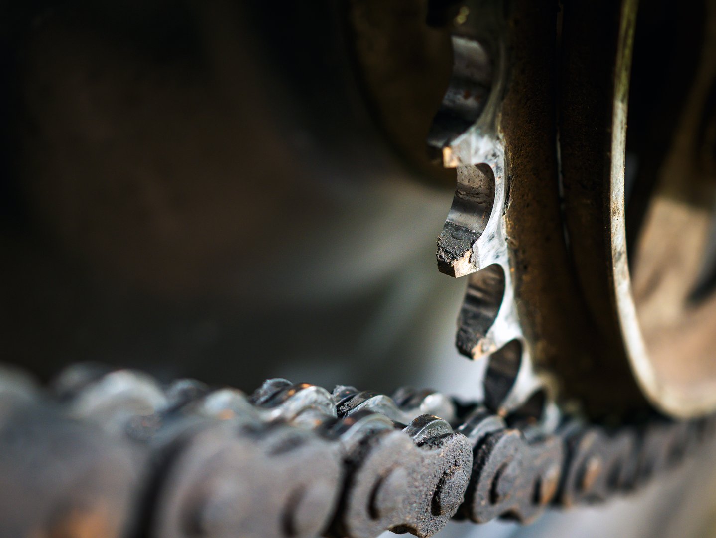 Motorcycle chain is attached to rear sprocket, Close up of dirty used motorbike chain. Rust motorcycle chain needs to be cleaned and greased