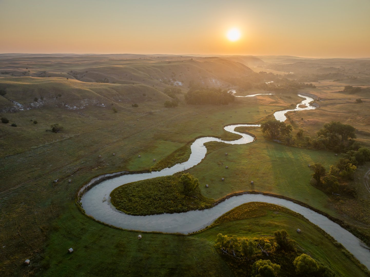 sunrise over a river meandering through Nebraska Sandhills - aerial view of Middle Loup River near Mullen