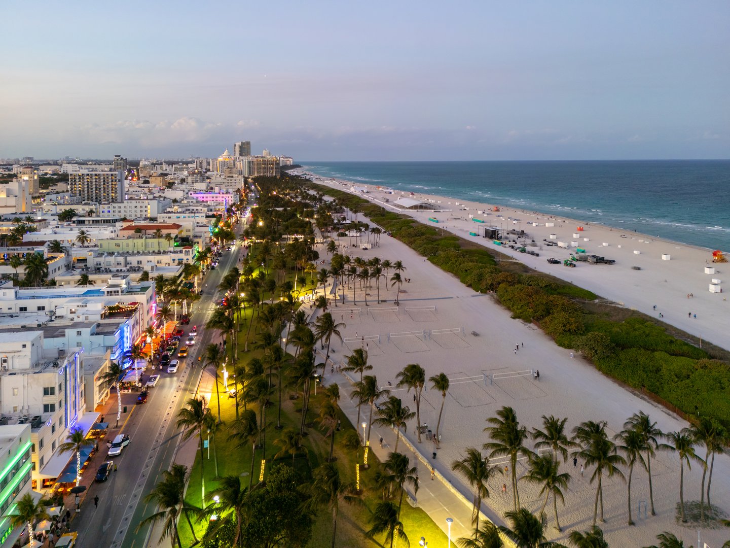 Cityscape of downtown Miami at night light. Famous Florida resorts and beaches. Midnight city lights in Miami. Waterfront view of Miami. Aerial shot of Miami at sunrise. Neon Art Deco. Ocean drive
