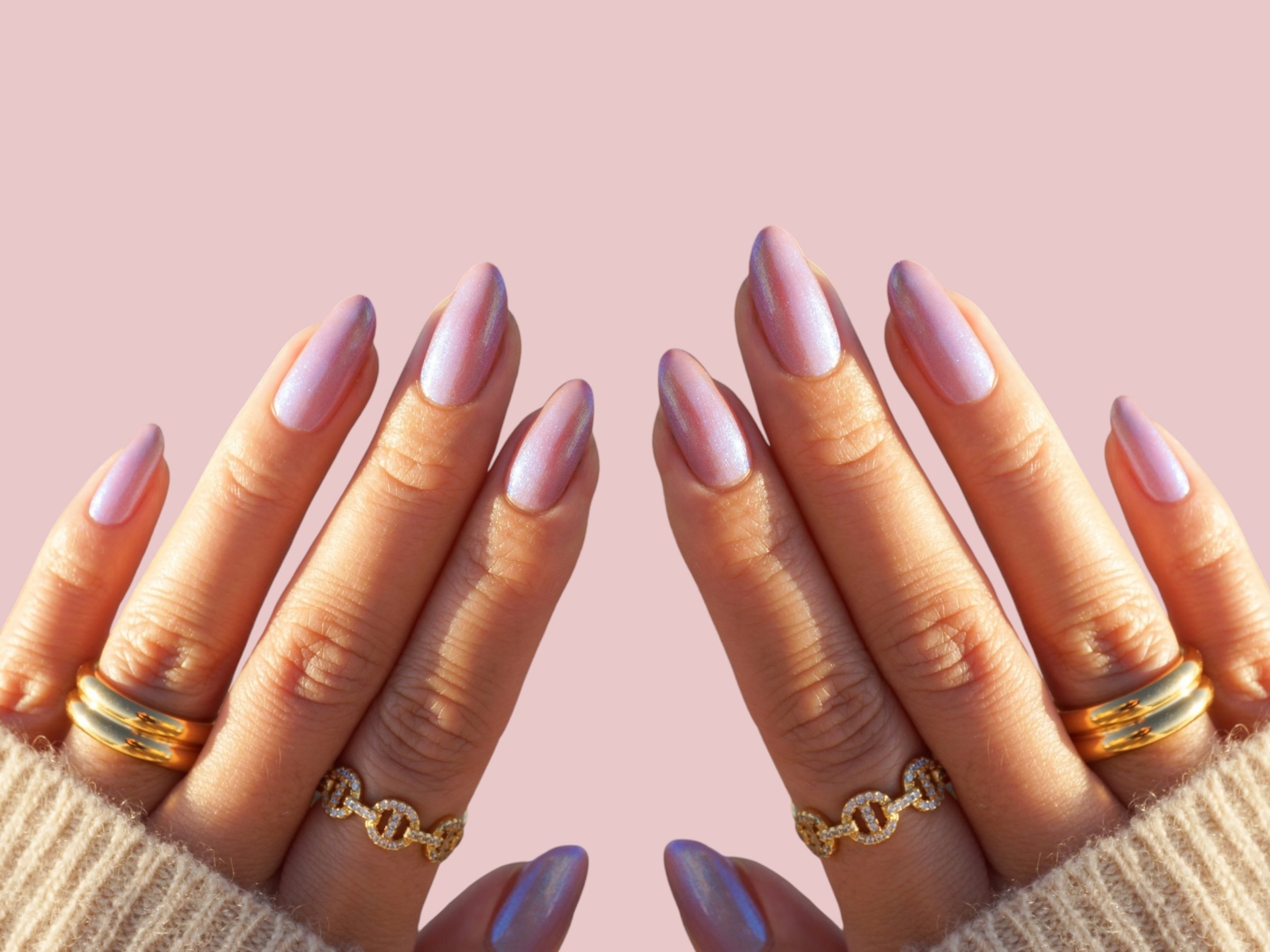 Young woman's hands and fingers in white with colorful nail manicure with trendy and modern shape with light background
