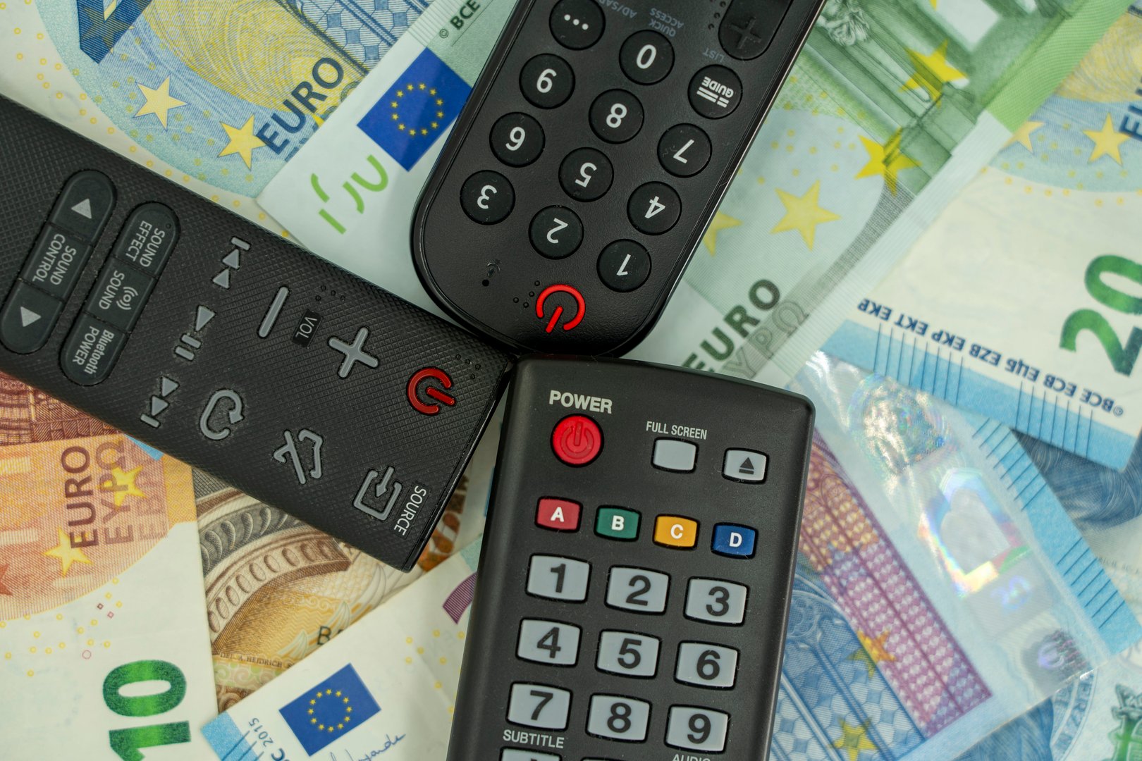 Money and TV remote showing cost savings