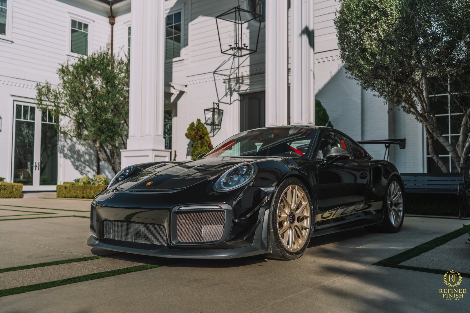 Luxury vehicle detailing showcasing mirror-like finish and paint protection