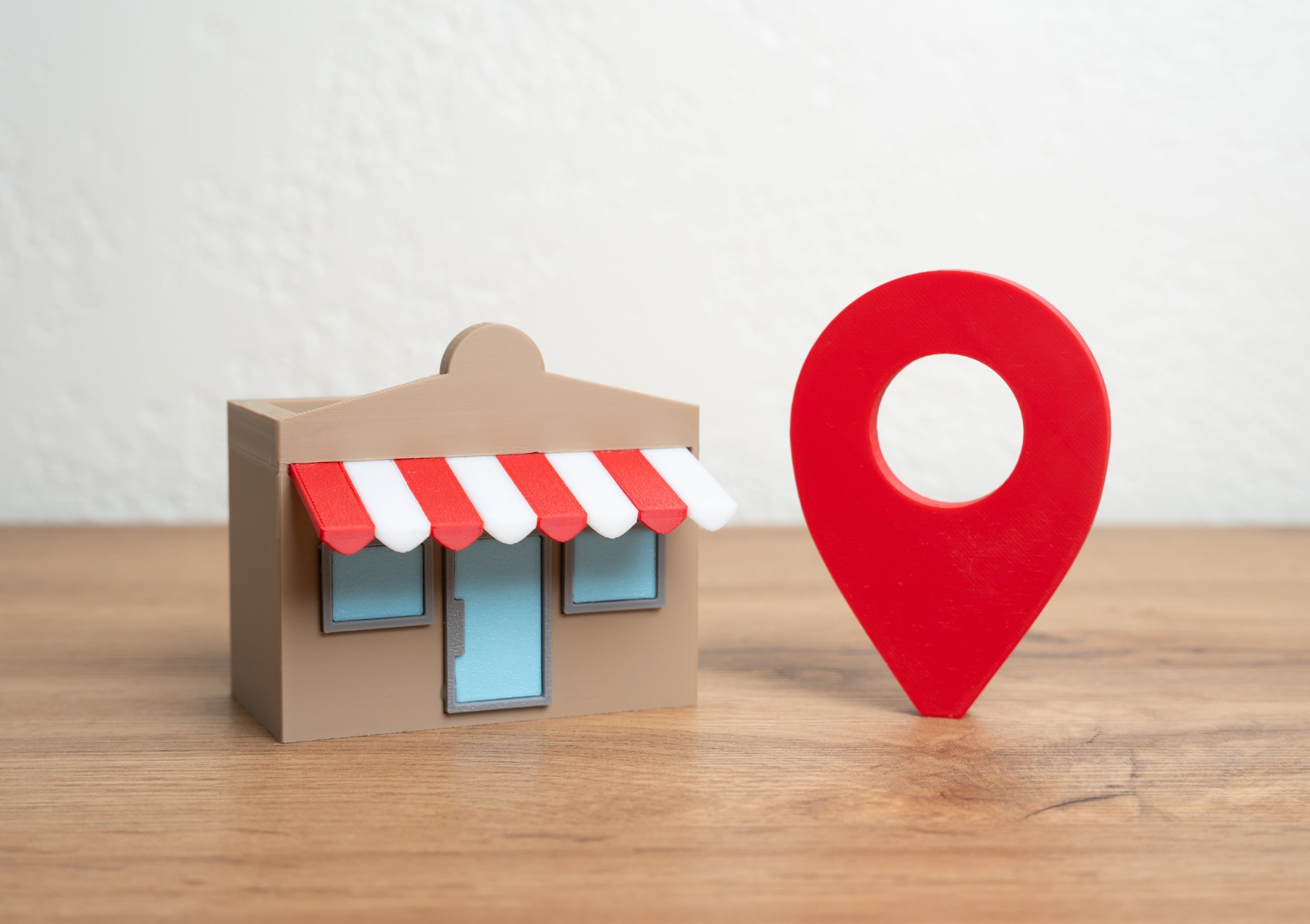 Shop and red geolocation sign. Advertising and presenting your business on maps and social networks. Geotargeting, SEO for businesses, or location-based customer acquisition.