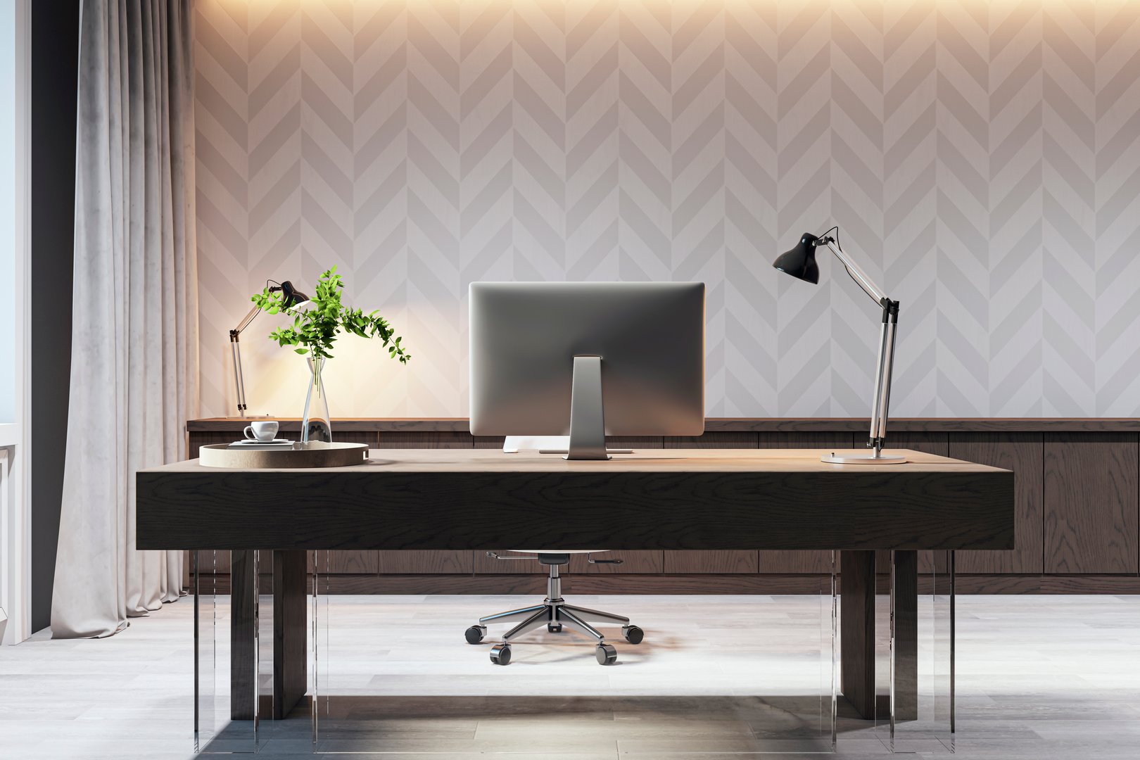Modern office desk with a computer monitor, elegant table lamp, and green plant, set against a geometric-patterned wall, concept of workspace. 3D Rendering